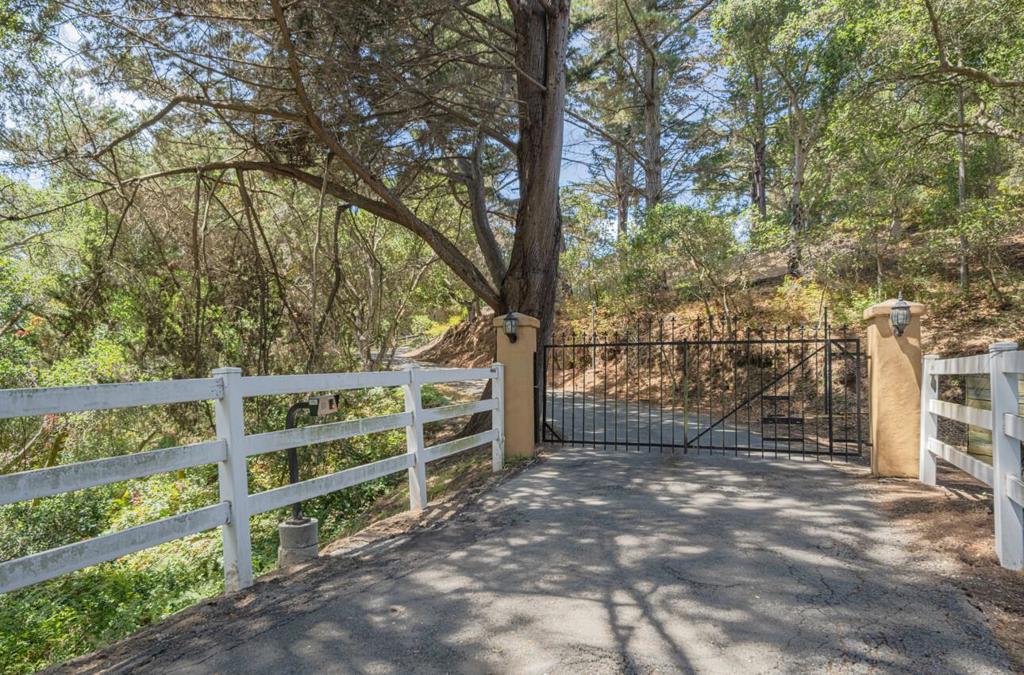 Beyond the Gate lies a private paradise with unobstructed panoramic views, secluded from neighbors & light noise - Imagine stargazing from the deck with sounds of the rippling waterfall. A perfect blend of luxury living & country charm. Open floor plan, Vaulted ceilings, walls of windows, 3 fireplaces throughout. Master bedroom suite has 2 bathrooms, a fireplace, 2 walk-in closets & French doors to a stunning solarium & glass-railed balcony where waterfall sounds fill the air - Think meditation area. The kitchen is light bright & wide open to living/family rooms w/ large island breakfast bar/walk-in pantry. Dining/Living combo opens to Al fresco dining area on expansive decking. Family/Media room w/wet bar opens to pavered outdoor entertaining w/ a pizza oven & horseshoe pits - Think marshmallow roasting. 3 car attached garage w/ abundant storage, plus a detached 2car garage in addition to a permitted 1,495 sqft barn w/ power: home office? hobby/play room? Ample RV, Boat, trailer & big toy parking, dog run, mudroom/indoor laundry, drip irrigation and circle drive around the water fall. Split rail perimeter fencing, private well/storage tanks & walking/riding trail access. Just minutes from shopping, restaurants, parks & beaches ... Yet it feels like you're Worlds away!