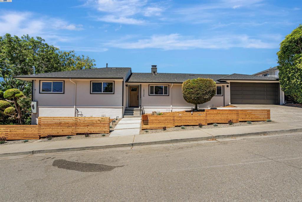 Welcome to 18945 Thornbury Avenue—a thoughtfully upgraded 3-bedroom, 2-bathroom home that blends timeless ranch charm with modern sophistication. Located in a sought-after Castro Valley neighborhood with access to highly rated schools, this home offers a clean, natural design aesthetic and a seamless indoor-outdoor lifestyle. Step inside to an open and airy layout with wide plank engineered hardwood flooring throughout. The fully remodeled kitchen features stainless steel appliances, sleek cabinetry, and a layout that opens effortlessly into the living space—perfect for both everyday living and entertaining. The primary suite offers a private retreat with a full ensuite bathroom, complete with a custom microcement accent wall that brings a spa-like texture and calm to the space. A second full bathroom is also stylishly updated with quality finishes. The living room features a cozy and eclectic fireplace framed by a microcement wall, tying together the home’s natural and modern tones. Outdoor upgrades include a contemporary horizontal redwood fence, drought-tolerant landscaping, and plenty of curb appeal with low maintenance. Additional improvements include a new tankless water heater, and a main electric panel upgrade—future-ready for solar and EV charger installation.