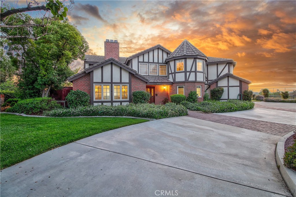 Welcome to this exceptional Tudor-style estate tucked away on a cul-de-sac, offering unmatched privacy, space, and timeless charm. This beautifully maintained home features 4 spacious bedrooms, 3 bathrooms, and a dedicated downstairs office, ideal for working from home or creating a quiet retreat. A dramatic grand staircase greets you upon entry, setting the tone for the home’s impressive design. Upstairs, the massive primary suite offers vaulted wood-beamed ceilings, a large walk-in closet, and abundant natural light. Three additional bedrooms are also located upstairs, making it a perfect layout for families. Enjoy the warmth of three fireplaces throughout the home and take advantage of multiple indoor and outdoor living areas perfect for relaxing or entertaining. The property features a tennis court with a basketball hoop, a custom storage shed, and an oversized two-car garage. Recent upgrades include a newer roof, newer septic system, and AC. The fully fenced yard and circular gated driveway add to the sense of security and seclusion. With panoramic views and a location that combines comfort, function, and beauty, this one-of-a-kind estate offers the ultimate lifestyle opportunity.