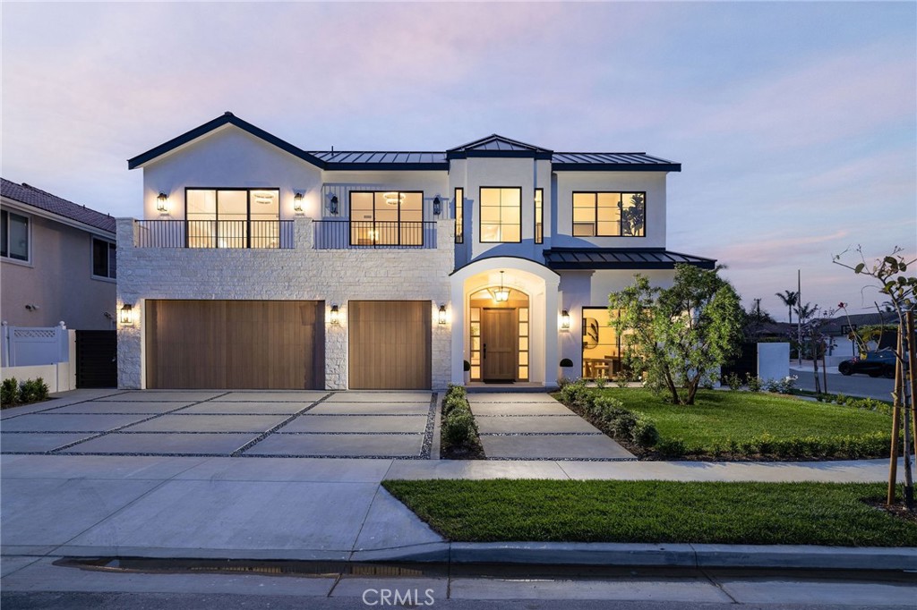 Brand new in 2025 and built to the highest standard, this custom coastal masterpiece sits on a premier corner lot in Huntington Beach with unobstructed ocean views from its expansive 560 sq. ft. rooftop deck. Spanning approximately 5,000 sq. ft., this architecturally striking home seamlessly blends warm organic textures with cutting-edge luxury. Step inside to soaring 11-foot ceilings with custom wood beam details and European white oak floors throughout. A dramatic LaCantina pocket door connects indoor and outdoor living, while natural light pours through Milgard windows and French doors. Entertain with ease in the show-stopping main kitchen featuring Taj Mahal quartzite counters, a 72” SubZero refrigerator, 48” Wolf range, SubZero wine fridge, and a stunning Taj Mahal quartzite wet bar with integrated sink. The adjacent butler’s kitchen offers additional prep and storage space for effortless hosting. The Belvedere book-matched marble fireplace creates a dramatic focal point in the great room, and a sleek elevator connects all levels of the home, including both laundry rooms—one on each floor. Designed with wellness and sustainability in mind, the home includes a solar system, metal roof, and extra-reinforced foundation. Retreat to the luxurious primary suite with vaulted ceilings, alabaster marble chandeliers, a private sitting area with stone fireplace, and a 30-foot balcony offering captivating ocean views. The spa-inspired bathroom boasts a full slab book-matched shower, Brizo polished gold fixtures, and a custom white oak vanity. A boutique-style walk-in closet showcases illuminated glass-front cabinetry in white oak. Additional features include a three-car garage, custom guest bathrooms adorned with Porcelanosa and Ann Sacks tile, and every luxury amenity expected of a modern coastal estate. 9121 Christine Drive is a rare offering—a statement home where no detail has been overlooked and every finish has been thoughtfully curated for those who demand the best in design, quality, and ocean-close living.