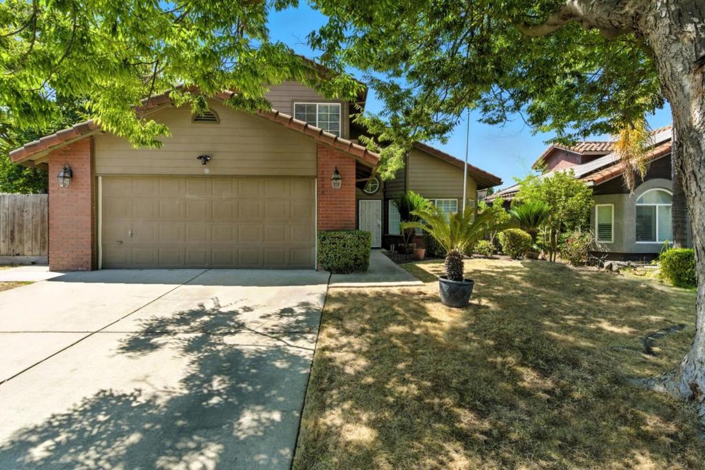 Nestled in one of Modesto's most desirable neighborhoods! This beautifully maintained 4-bedroom, 3-bathroom home sits on a spacious corner lot and features a full bedroom and bathroom downstairs, ideal for guests or multigenerational living. Step inside to soaring ceilings, fresh interior paint throughout, and elegant tile flooring on the main level. The bright kitchen shines with stainless steel appliances and sleek black countertops. Upstairs, you'll find cozy carpeted bedrooms and plenty of natural light. Enjoy morning coffee or evening gatherings in the private backyard with mature fruit trees and room to relax or garden. Located in a quiet, established community near parks, shopping, and great schoolsthis home offers the perfect blend of comfort and convenience. Come experience the lifestyle you deserve!