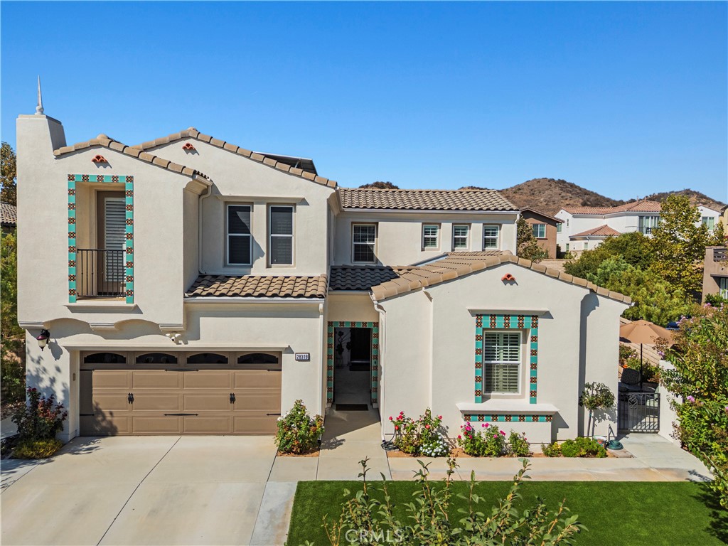 Located in the prestigious gated community of West Hills, Monument Collection and designed with a highly sought-after Next Gen floorplan, you'll find this stunning 5-bedroom, 5-bath home complete with attached 1 bed-1 bath CASITA that includes kitchen and laundry. From the moment you arrive, the romantic Spanish architecture makes a lasting impression. A gated breezeway, accented with wrought iron and Spanish tile, leads to the main entrance, while a separate exterior entrance provides a private yard and direct access to the Casita. The Casita is also accessible from inside the home, making it an ideal retreat for multi-generational living, guests, or extended stays. Recently remodeled, the Casita showcases luxury vinyl plank flooring, a skylight with automatic shade, a new kitchen featuring custom cabinetry, glass tile backsplash, and Corian counters. The remodeled bathroom features a walk-in tile shower, custom vanity, and stylish flooring. But wait, the main home is also a show stopper and perfectly blends beauty and versatility too! The first floor of the main home offers the convenience of a bedroom and attached full bathroom plus a nearby half bath. You'll also find an expansive kitchen with eat in dining area that opens seamlessly to the family room, highlighted by a cozy fireplace and custom built-in bookcases—an ideal space to relax. Formal dining room provides an additional entertainers space. Upstairs, you’ll find four additional bedrooms plus an enclosed bonus room, perfect for a den or office (no closet). Two of the upstairs bedrooms serve as primary suites, each with its own bathroom, and one even includes a private retreat. Enjoy the beautifully landscaped backyard with low-maintenance artificial turf, cemented side yard, stamped concrete, pergola, and an assortment of mature fruit trees--backyard drainage improvements add peace of mind. Additional upgrades throughout include: OWNED SOLAR, recessed lighting, smart outlets, led lights, ceiling fans in every room, extended closet shelving, water softener, a newer tankless water heater, artificial turf in front yard and enlarged driveway. This home also comes with a 3-car tandem garage with mini A/C split and insulated garage door. There is truly no other home like this on the market! Offering generous space, thoughtful updates, and flexible living options, this property is move-in ready and waiting for its next owners. Inquire today to experience all that this exceptional home has to offer!