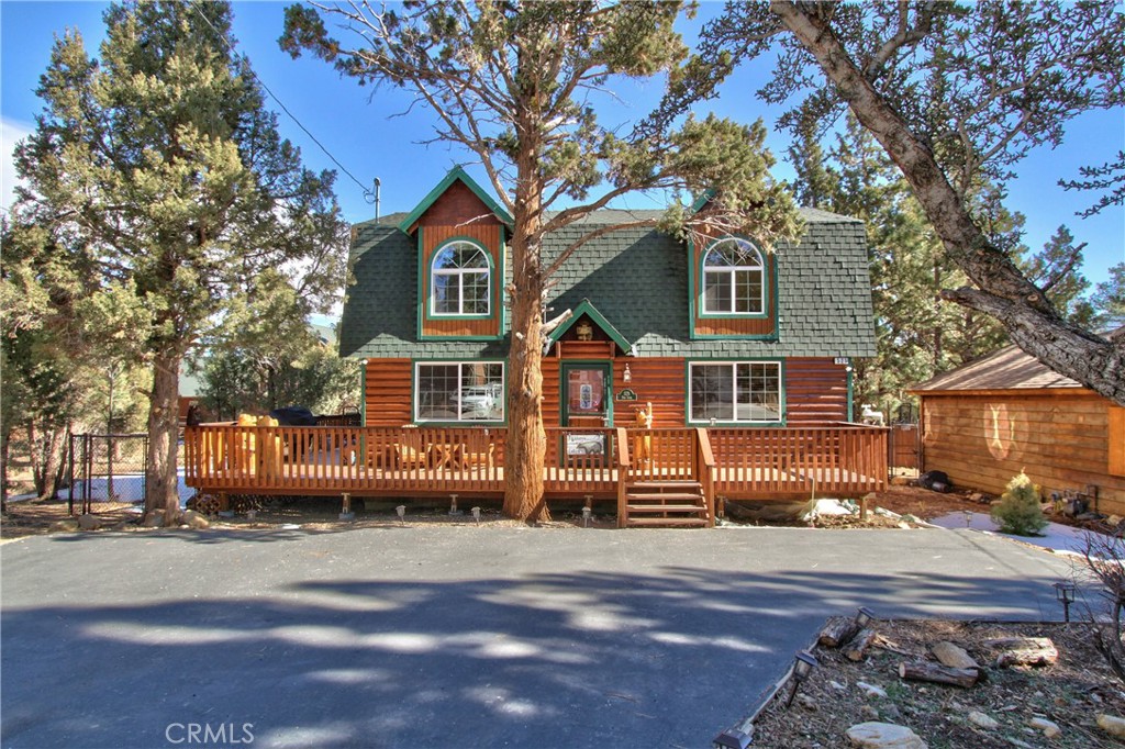 Beautiful log style home located in a quiet setting on the eastern edge of Sugarloaf backing up to Meadowbrook Estates. This property sits back from the street on a 4,500 sf level lot with a paved driveway, 3 bedrooms, 2 baths and over 1300 sq ft of living space. Enjoy the outdoors on the extra large wrap around deck u under the mountain air. Warm mountain feel throughout with a cozy river rock fireplace, exposed beam ceiling and pine cabinetry and accents. Large open floorpan and a laundry area. Tuff shed in back for storage. All necessary appliances will convey. Near national forest and everything Big Bear has to offer. Walking distance to Baldwin Elementary school and Big Bear High.