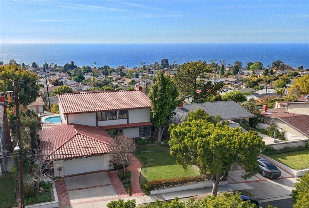 View! View! View! Don’t miss the opportunity to live in this PANORAMIC OCEAN VIEW home that has been thoughtfully updated throughout the years. Highlights include newer paint, wood floors, smooth ceilings with recessed lighting, Pella windows & sliders, Hunter Douglas shades, remodeled bathrooms, a resurfaced fireplace, central A/C & heater and a solar system. A picturesque red brick walkway surrounded by a landscaped path and a grassy lawn leads to the welcoming double-door entry. Inside, the spacious living room showcases an LED back-lit quartzite fireplace, with sweeping ocean views as the backdrop. Step through the sliding door to enjoy the sparkling pool and bubbling spa - perfect for entertaining. The family room opens to a serene side yard, ideal for BBQs and gatherings. Meanwhile, the bright kitchen makes cooking a joy, offering a formal dining area, a casual breakfast nook, and breathtaking ocean & Catalina views. ON THE UPPER LEVEL, the expansive primary suite boasts oversized windows framing endless blue horizons, a large closet, and an ensuite bathroom. There is another bedroom with a great ocean view and 3 other good size bedrooms on this level. A large hallway full bathroom upstairs and a finely appointed powder room downstairs complete this family residence. Ideally located near parks, golf courses, top-rated schools, shops, restaurants, and the best of Palos Verdes outdoor living. This is more than a house—it’s home!