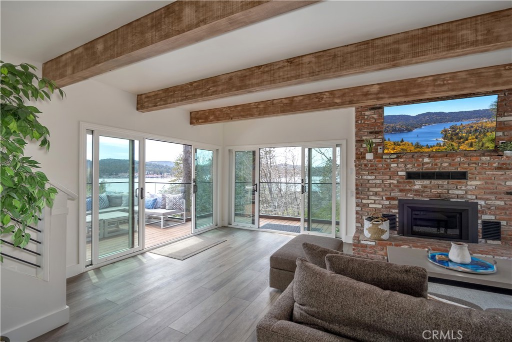 Embrace the allure of lakefront living at this stunning residence, set in the coveted Palisades neighborhood of Lake Arrowhead. This remarkable home offers a street-level entry, ensuring ease of access to a beautifully remodeled sanctuary.
Spanning four bedrooms and three exquisite bathrooms, the interior of this home has been thoughtfully reimagined to blend modern elegance with classic charm. The addition of a large den provides a versatile space for relaxation or entertainment, while two spacious decks offer the perfect setting for outdoor enjoyment with breathtaking lake views.
Each bedroom presents vistas of gorgeous Lake Arrowhead, ensuring a serene retreat at the end of each day. This home grants much-coveted lake rights, enhancing your connection to the water. Furthermore, an available 1/2 double dock, complete with a storage shed, provides the perfect launch point for aquatic adventures.
This Palisades gem is more than a home; it is a gateway to an exceptional lifestyle. Don't miss the opportunity to make Lake Arrowhead your backdrop. Contact your Compass listing agent to arrange a private viewing of this elegant retreat.