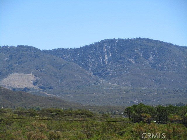 Who wants a view property with improvements?! Amazing views will greet you from this improved 5 acre property with WELL, ELECTRICITY, & FULL FENCING. Recent electrical upgrades include 3 RV hookups. One RV will remain. Enjoy views of Cahuilla Mountain, Thomas Mountain, and Mt San Jacinto to the north and west, and valley views to the south and east. This parcel has it all!