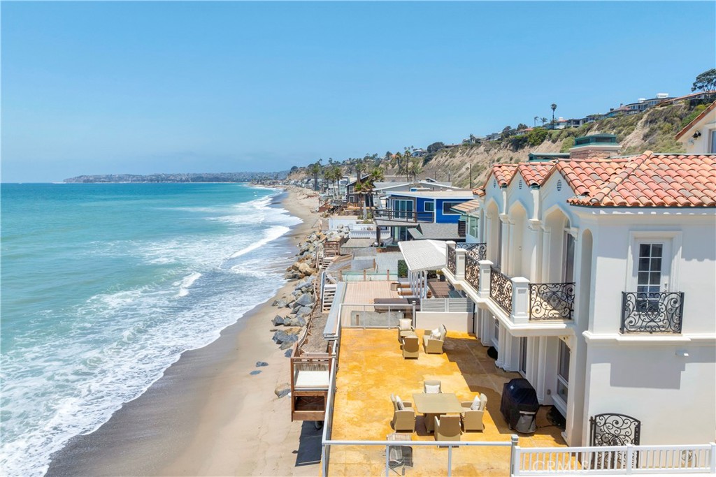 Luxury Custom-Built Beachfront Estate | Dana Point Welcome to coastal luxury redefined. Situated directly on the sand in a prestigious guard-gated community in Dana Point, this custom-built beachfront estate offers an unparalleled blend of sophistication, comfort, and breathtaking views stretching from the Dana Point Harbor to Catalina Island. Boasting 5 spacious bedrooms and 5.25 bathrooms, this exquisite home is thoughtfully designed for both grand entertaining and everyday relaxation. A private elevator connects all levels, leading you to standout features including a movie/game room, two full bars, and a rooftop deck with fireplace—the perfect setting to enjoy spectacular sunsets over the Pacific Ocean. Indulge in seamless indoor-outdoor living with multiple balconies, panoramic ocean and harbor views, and direct beach access. Every inch of this residence showcases luxury craftsmanship, from the gourmet kitchen to spa-inspired baths and open-concept living spaces. Nestled within a 24-hour guard-gated enclave, this home offers unmatched privacy while being just minutes from world-class dining, upscale shopping, and the vibrant coastal lifestyle of Dana Point. Live the beachfront dream — where elegance meets the ocean.