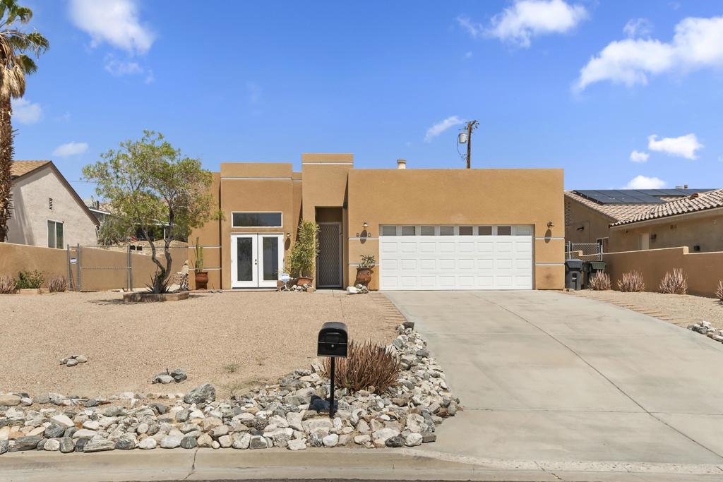Welcome to your dream Santa Fe home, where panoramic mountain views greet you from every angle! situated above Mission Lakes Blvd, this property is designed for comfort and style. Featuring three generously sized bedrooms and two bathrooms, the home is enhanced by 10-foot ceilings, creating an open and airy feel. The large kitchen, complete with tile countertops and a pantry, is perfect for gatherings. Entertain effortlessly in the separate dining room with access to a patio for outdoor dining, or unwind in the spacious living/family room with its inviting fireplace. The primary suite boasts a convenient walk-in shower. Practical features include inside laundry, tile flooring in common areas, carpet in the bedrooms, and laminate in the kitchen. Prepare to be impressed by this home's charm and proximity to downtown Palm Springs, surrounding desert cities, and the natural beauty of Joshua Tree National Park.