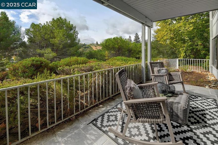 Secluded, end-unit, Carmel, with a lovely, unobstructed view of rolling hills. This 2 bedroom, 2 bath, home is tucked away in a private and peaceful pocket of Rossmoor that provides beautiful views from the primary bedroom and covered back patio. One of the few models that has two separate outdoor spaces to enjoy the beautiful setting and weather. The large patio in the front is shaded by a majestic Japanese Maple tree. In the back there is a covered patio with a gated side yard that provides an ideal space for a person with a dog as well as a gorgeous view. Inside you'll find many upgrades like hardwood floors, smooth ceilings, LED light fixtures, and some dual pane windows. Both bathrooms have been updated with marble tiled showers and sleek finishes. This is one you'll want to consider.