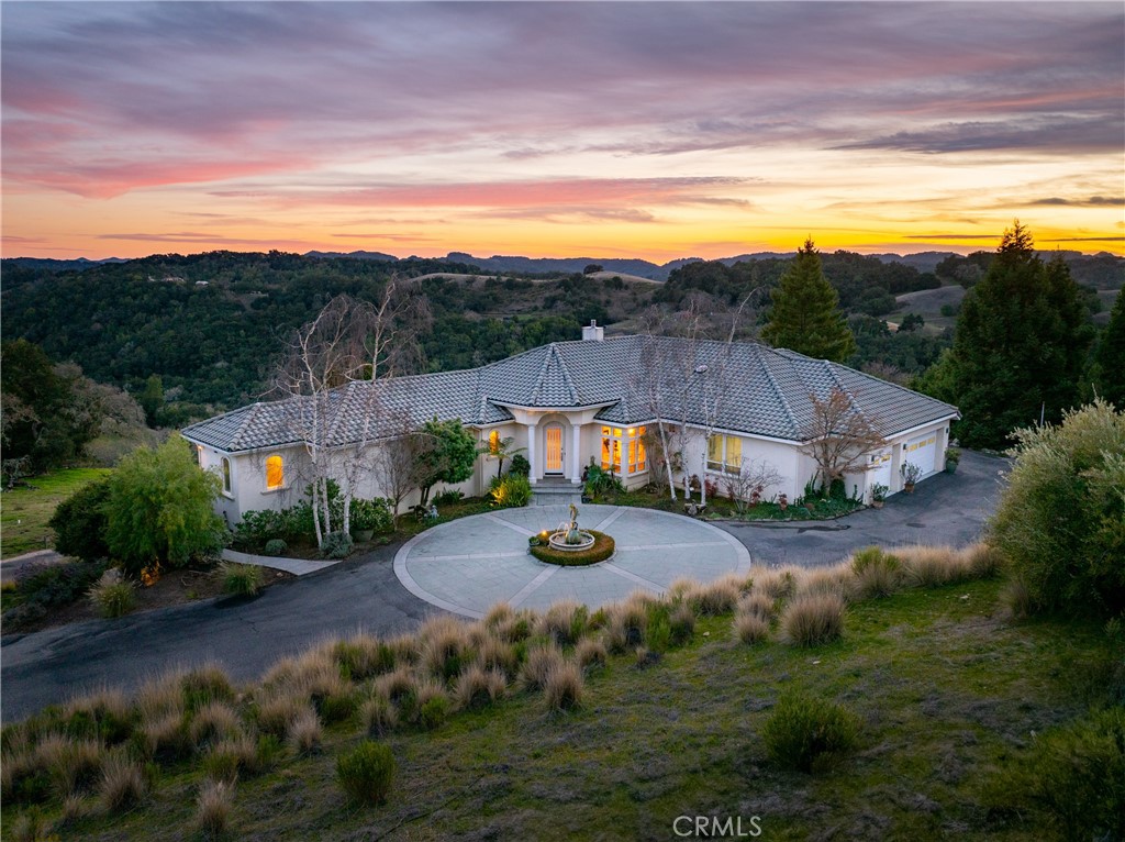 Welcome to Rancho Notso Grande! Nestled high on a hill overlooking the breathtaking Paso Robles countryside, this remarkable 20-acre estate features two homes, offering an ideal setup for multi-generational living or a lucrative investment opportunity. Surrounded by world-class vineyards and located just a short drive from Paso Robles, Templeton, Cayucos, and Cambria, this property blends elegance, functionality, and stunning views.
The main home, is a luxurious single-level retreat currently operating as a highly rated AvantStay short-term rental. The open-concept design boasts vaulted ceilings and a welcoming living area centered around a cozy fireplace. Inside, the main living room features large windows that bathe the space in natural light while framing awe-inspiring vistas. The entertainer’s dream kitchen includes double ovens, a Dacor warming drawer, custom cabinetry, a walk-in pantry, a temperature-controlled wine room, and a solar tube for added light. The primary suite is a bright sanctuary with a spacious closet, ample natural light, and an en-suite bath featuring a soaking tub and separate shower. Three additional bedrooms offer plenty of accommodations for family or guests. Outside, the expansive patio leads to an infinity pool, a hot tub, and a built-in gas BBQ, where you can unwind and take in the rolling hills and valleys. Solar power and a Tesla battery backup ensure efficiency and reliability and equipped with a whole-house generator, this home ensures power during any outage, providing peace of mind and convenience by powering the entire home when needed.
The second home, located at 4344 Shadow Canyon, is a beautifully remodeled 3-bedroom, 2-bath residence with modern upgrades, including new stainless steel appliances, stone countertops, and soft-close cabinetry. The master suite offers a large walk-in closet, outdoor access, and a sleek en-suite bath. Additional features include a bonus room off the garage, a spacious indoor laundry room, and its own meter for electricity with Tesla battery backup. The landscaped yard includes fruit trees and vinyl fenced yard area with grass and covered patios.
This estate also offers a covered RV area, a golf cart garage, and numerous additional amenities, making it a versatile and exceptional property. Whether you're seeking a luxurious lifestyle, a family compound, or an income-generating opportunity, this unique estate is sure to impress.