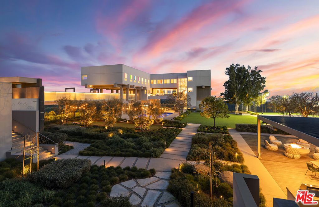 Originally designed in 1986 by renowned architect Ted Tanaka, this world-class architectural marvel underwent a five-year structural remodel and addition completed in 2021 under the direction of Clive and Julie Bridgewater, along with landscape architect Pamela Burton. Crafted for a young collector family seeking the ultimate modern view estate to showcase art in a family-oriented setting, it serves as a hub for major art installations and esteemed art-world gatherings. Tucked behind two sets of iron gates at the end of a long driveway within a cul-de-sac, this extraordinary private 3.2-acre knoll boasts uninterrupted city, ocean, and reservoir views, enveloping the estate in electrifying vistas from every room inside and outside. With a lit tennis court offering arguably the most breathtaking views in town, two elevators - one for the main home and one for the guest house, and outdoor events two kitchens, one for the main floor for intimate breakfasts and family meals, and another strategically positioned with walls of glass opening to the outdoor barbecue area, for family weekend fun and large-scale events. Additionally, a theater with wine room and soda fountain, game and billiard room. Within the sprawling flat grounds a spectacular oversized pool, full barbecue/pizza kitchen, as well as covered outdoor areas and decks throughout the property. This light-filled home embraces the love of art and family values, offering an unparalleled lifestyle experience.