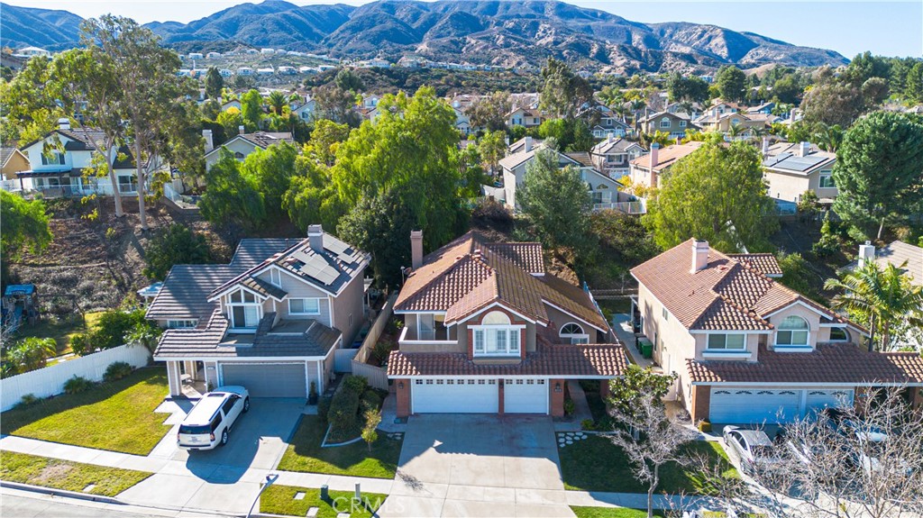 Nestled in a quiet, family-friendly neighborhood just off Green River, this beautiful Sierra Del Oro residence offers comfort, space, and convenience. With 5 bedrooms and 3 full bathrooms, the layout is ideal for families of all sizes.
The main level features a versatile bedroom with a full bathroom nearby—perfect for guests, in-laws, or a private home office. High vaulted ceilings and fresh interior paint create a bright, open feel throughout. The home also includes an in-house laundry room and direct access to a 3-car garage.
Upstairs, you’ll find 4 additional bedrooms, including a large primary suite with its own bathroom, a secondary bedroom with a private balcony, and an oversized room that offers extra flexibility.
The backyard is designed for both relaxation and entertainment, complete with a covered patio, grassy area for kids or pets, and low-maintenance landscaping. Laminate wood flooring and tiled bathrooms add a modern touch.
Located just minutes from Orange County and major freeways, this home combines suburban peace with excellent commuter access.