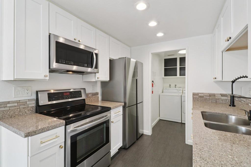 Turnkey condo that feels like a townhome. Greenbelt views in the desirable Whelan Ranch community. This beautifully newer upgraded 2-bedroom, 1.5-bath home offers 1,104 sq ft of light-filled living space and a peaceful, park-like setting with no neighbors above or below. The newer remodeled kitchen features modern countertops, stainless steel appliances, updated fixtures, and stylish flooring. Additional improvements include a new water heater, efficient A/C unit, and laminate wood flooring throughout. The open-concept layout includes a spacious living area, in-unit laundry with extra storage, and a large private patio—ideal for outdoor dining, relaxing, or entertaining. Enjoy the convenience of a one-car attached garage with direct access, plus an additional assigned parking space. The community features a sparkling pool, spa, playground, and plenty of guest parking nearby. Located just minutes from beaches, Camp Pendleton, shopping, dining, and commuter routes, this home offers the perfect combination of comfort, value, and location. Move-in ready condition make this a standout opportunity in Oceanside. Don’t miss your chance to own in one of North County’s most sought-after neighborhoods. Includes a 3 Year Home Warranty.