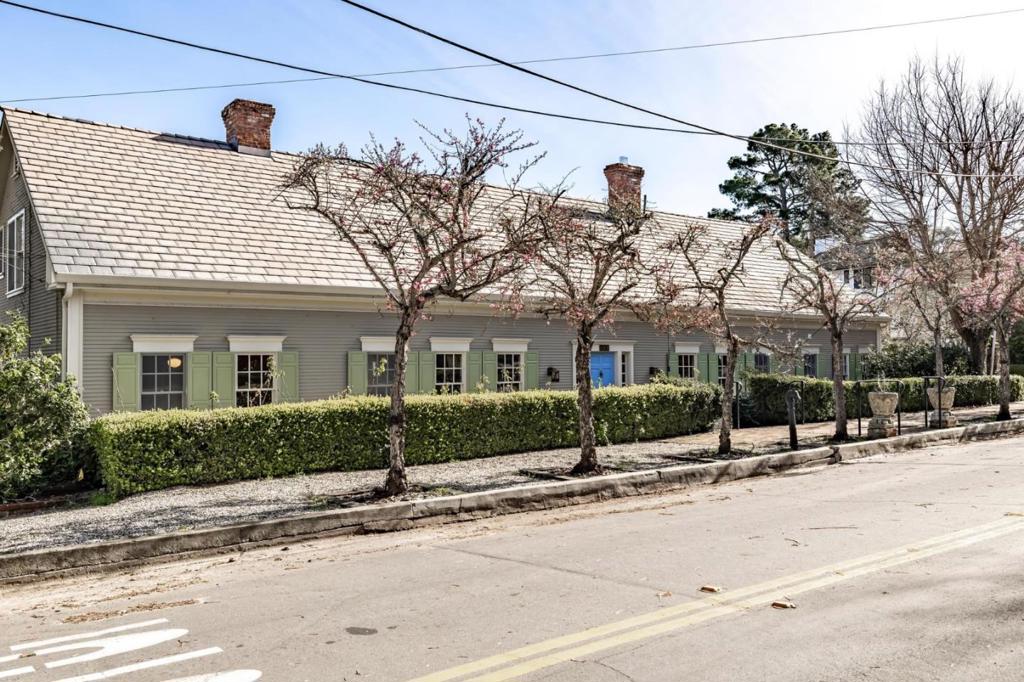 Refreshed, reimagined and utterly ravishing, this architecturally-significant home weds East Coast refinement to West Coast ease. Styled after the Raleigh Tavern in Colonial Williamsburg, the expansive, light-filled house features a generous 5,000+ square feet of beautifully-designed living space in the heart of Monterey. 6 spacious bedrooms each with en suite bathrooms, formal dining room, library, family room and a stunning 2-story living room with vaulted ceiling, this home inspires gatherings with friends and family. A gleaming, brand new kitchen with top of the line appliances, cabinets, custom paint and designer lighting fixtures add to the incredible sense of spaciousness and flow throughout. A newly installed elevator makes upstairs/downstairs living a breeze and the large 2 car garage is equipped with modern car charger outlets. There is also a charming attached apartment, perfect for guests, caretakers or a rental unit. Enormous curb appeal, with curated outdoor spaces in which to entertain or simply relax. Meticulously maintained and located in the Peters Gate area, near Whispering Pines and Via Paraiso Parks, schools, the Del Monte Shopping Center, and downtown Monterey.