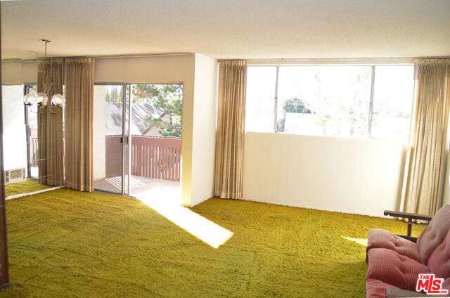 Fantastic opportunity to own a top floor south-facing corner end unit with minimal shared wall space, exceptional natural lighting, & boasting delightful treetop, courtyard, & jetliner views. Enjoy a galley kitchen that opens to both the dining & living areas. A large wall of windows frame the views and the sliding glass door opens to an inviting outdoor balcony. The master ensuite is private & quiet & features a roomy walk-in closet. Laundry room located just one door away & the unit also comes with 2 separate parking spaces, which is rare for a 1-bedroom condo. Amenity-rich complex offers an outdoor pool & sundeck, fitness center, saunas, well-manicured grounds, & clubhouse with game room & onsite staff & manager. Fox Hills Park is a mere one block away & an abundance of retail shops, restaurants, & grocery stores are nearby. Easy freeway & airport access for commuting. Property needs significant updating and is the perfect canvas for the creative buyer to design & update as desired.