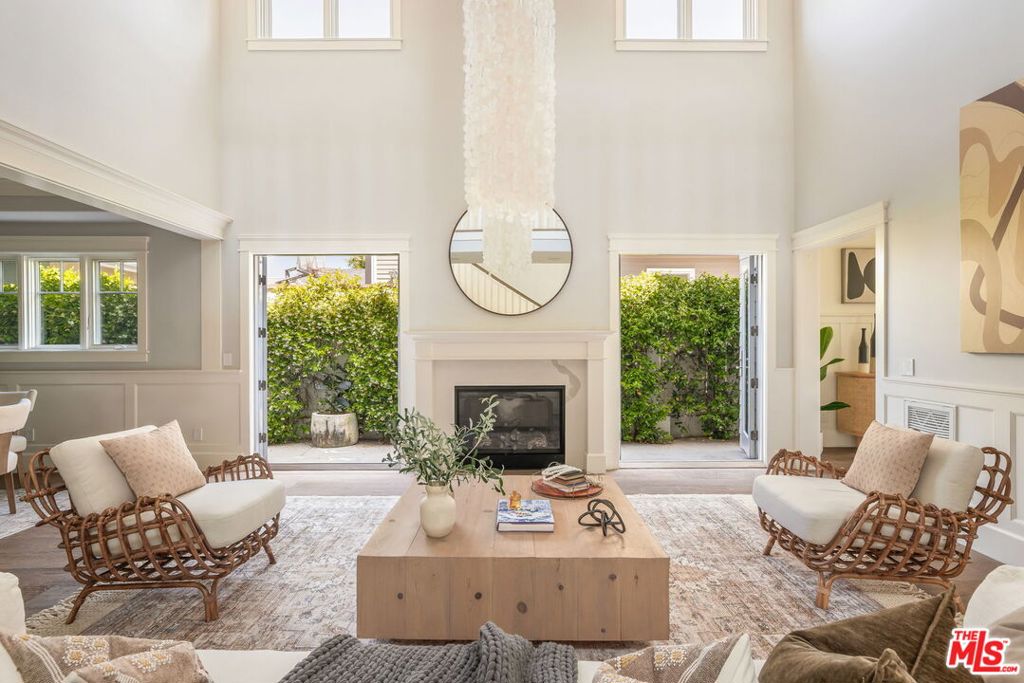 Experience the perfect blend of East Coast elegance and California ease in this stunning residence located in the heart of Sunset Park. The formal living room with 25' stunning high ceilings and a fireplace immediately sets a warm and inviting tone. The heart of the home, a chef's kitchen with Wolf appliances and a gorgeous walk-in pantry that you will fall in love with, flows into a comfortable family room with custom built-ins and plenty of space for your cozy nights in with friends and family. All of the main living spaces downstairs open on to a beautifully hedged, private backyard, creating seamless indoor-outdoor living. Upstairs is the perfect blend of color, craft and design. The 4 bedrooms are bright, spacious and beautifully designed. The primary suite features double walk-in closets and a private deck overlooking the yard. Additional highlights include a laundry and mud room, a 2-car garage, and a prime location just steps from top rated schools, cafes, eateries, and the beach.