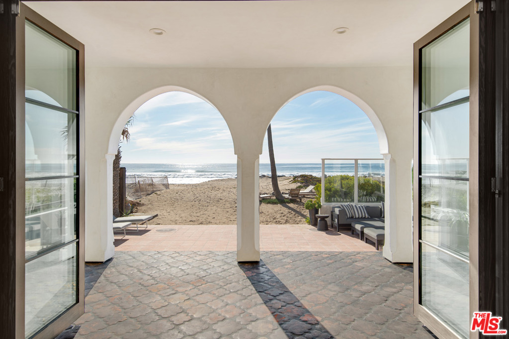 Most people dream of such a place, while others dream of owning it! This is your chance to experience the Malibu life at this impeccable beach compound. Designed to entertain, situated on a deep lot with sandy beach. The home was stripped to the studs and reimagined by an acclaimed AD100 celebrity designer, Michael Lee, who brought a unique blend of modern finishes & integrated rustic touches, all giving it that elegance throughout while still maintaining the comfort of the coastal living vibes. A light-filled Moroccan masterpiece with open spaces, 12-14' ceilings, a master suite you would never leave with views of the famous Zuma Beach, a Chef's kitchen, large outdoor patios including lush gardens & a courtyard w/ a moorish shaped pool. In addition, it has a very rare direct access to the ocean, without rocky obstacles. Other amenities include a secure gated entry, built-in bbq, solar w/ a Tesla charger & 3-car garage. For sale or lease - can be sold furnished.