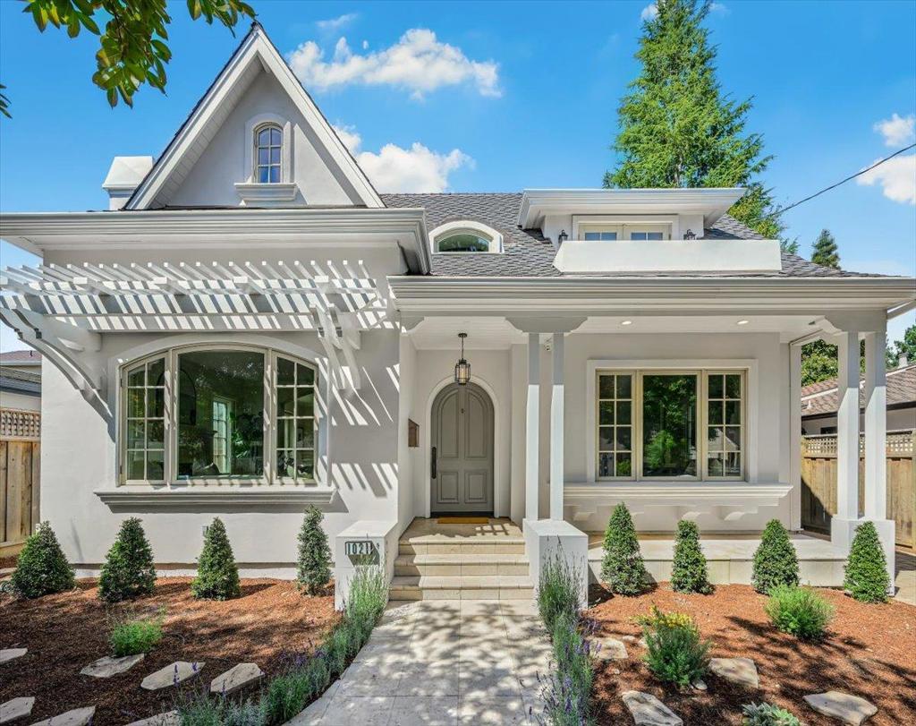 Elegant and timeless, this custom-built 2004 residence in Palo Alto's prestigious Crescent Park neighborhood combines enduring craftsmanship with modern comfort. The home's refined white façade and landscaped front entry welcome you along a picturesque tree-lined street. Inside, a grand foyer with soaring ceilings introduces a spacious and light-filled interior. Distinctive ceiling lines, arched hallways, and custom millwork add architectural characters throughout, while rich hardwood floors, stone finishes, and designer lighting provide a sophisticated yet inviting atmosphere. The living room flows seamlessly into the formal dining room, making it ideal for both intimate gatherings and elegant entertaining. A chef's kitchen with a built-in refrigerator opens to a casual dining area and family room, where large windows overlook the serene backyard. The main level also features a guest bedroom and a full bathroom, offering flexibility for guests or multi-generational living. Upstairs, the primary suite serves as a private retreat with vaulted ceiling, symmetric windows, a walk-in closet, and a spa-inspired bathroom featuring a double vanity, walk-in shower, tub, and stone countertops. Additional bedrooms offer bright and versatile spaces for family, guests, or a home office.