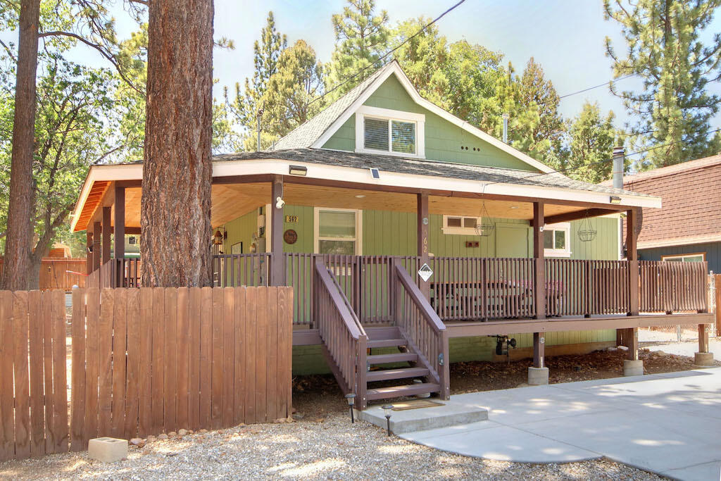 Come See Your Next Mountain Home or Investment Property! This beautifully updated 3-bedroom, 2-bath mountain home sits on a spacious 9,400 sq ft street-to-street lot with plenty of room to build a garage while still enjoying a large yard and RV/boat parking. Whether you're looking for a full-time residence, a weekend getaway, or a vacation rental, this property has it all. Beautiful spacious walk around covered deck. Hot tub to enjoy the clear star filled Big Bear skies. Inside, you'll find a tastefully remodeled interior, including a luxurious primary suite featuring a king-size adjustable bed with massage function and generous closet space. The updated kitchen shines with finely crafted shaker-style cabinetry, and the cozy living room is anchored by an efficient wood-burning stove--perfect for chilly mountain evenings. Upstairs, two additional bedrooms offer nice separation for guests or family. A full-size stackable washer & dryer adds everyday convenience. Step outside to enjoy nature from the huge, low-maintenance wraparound deck, complete with a 10-foot picnic table--ideal for outdoor entertaining. Relax in the nearly new hot tub, tucked into the fully fenced backyard for added privacy. There's parking for 6+ vehicles outside the fenced area, along with dedicated RV/boat space.
