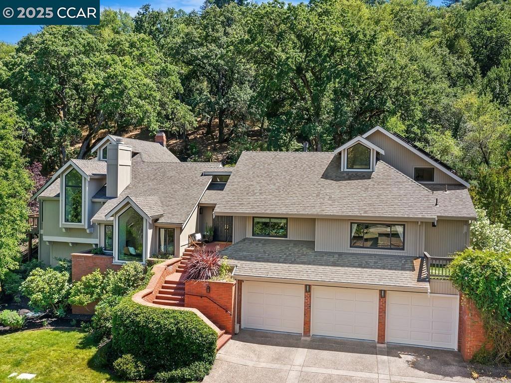 Situated on a private lane in the heart of Happy Valley in one of the most sought-after Lafayette neighborhoods, this stunning home is a true retreat. Dramatic high vaulted & beamed ceilings, expansive walls of glass & numerous glass doors flood the interiors with natural light & frame serene views from every angle. The living areas are open & spacious, & the floor plan is thoughtfully designed for the California indoor/outdoor lifestyle — perfect for entertaining or enjoying peaceful everyday moments. Modern lighting, updated hardware, Anderson windows & glass French doors, oak hardwood floors. Chef’s kitchen + bar area with wine refrigerator & ice maker. Lux primary retreat offers sitting/office/gym area. Renowned for its vibrant springtime display of thousands of daffodils, the spectacular 1.5-acre property is a breathtaking blend of natural beauty & privacy. With a waterfall, rope swing, trellis covered al fresco dining, raised veggie beds, & an impressive list of trees, incl 9 olive, apple, pomegranate, cherry, peach, nectarine & apricot, the property has lots to discover. 3 car garage with wine cellar. Solar, 2 Tesla power walls, 2 220V outlets. Located just a short walk to top-rated HV Elem, this home offers unbeatable convenience. Enjoy quick access to town & Bart.