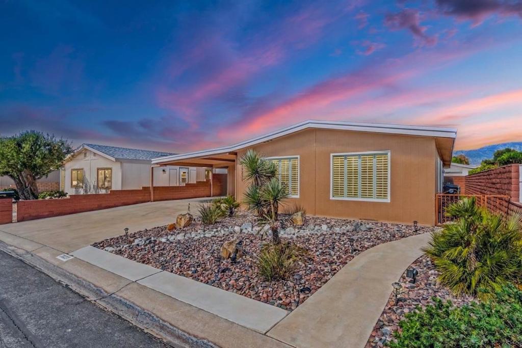 This beautifully updated 2-bed 2-bath home with striking curb appeal sits on a permanent foundation offering 1,440 SF of stylish & comfortable living. The modern kitchen features white granite countertops, pull-out cabinets, soft-closing drawers, recessed lighting & brand-new stainless steel fridge. The large primary boasts a custom closet with built-ins & both bathrooms have been tastefully remodeled with large tiled showers. Enjoy year-round comfort with dual-pane windows, ceiling fans, crown molding, plantation shutters & newer central A/C, plus an eco-friendly evaporative cooler. Tile flooring & fresh paint inside & out add a crisp, clean feel throughout the home. A dedicated laundry room provides added convenience. Outside, relax or entertain under the spacious, private covered patio surrounded by lush landscaping plus low-maintenance artificial turf. A charming ''she shed'' offers space for hobbies or storage. The large driveway includes covered parking, plus separate golf cart parking with its own charging station. This move-in-ready home blends comfort, style & practicality--perfect for modern desert living. Palm Desert Greens is an active adult community offering golf, tennis, pickleball, fitness, swimming & 24-hour security, all for the affordable monthly amount of $400.
