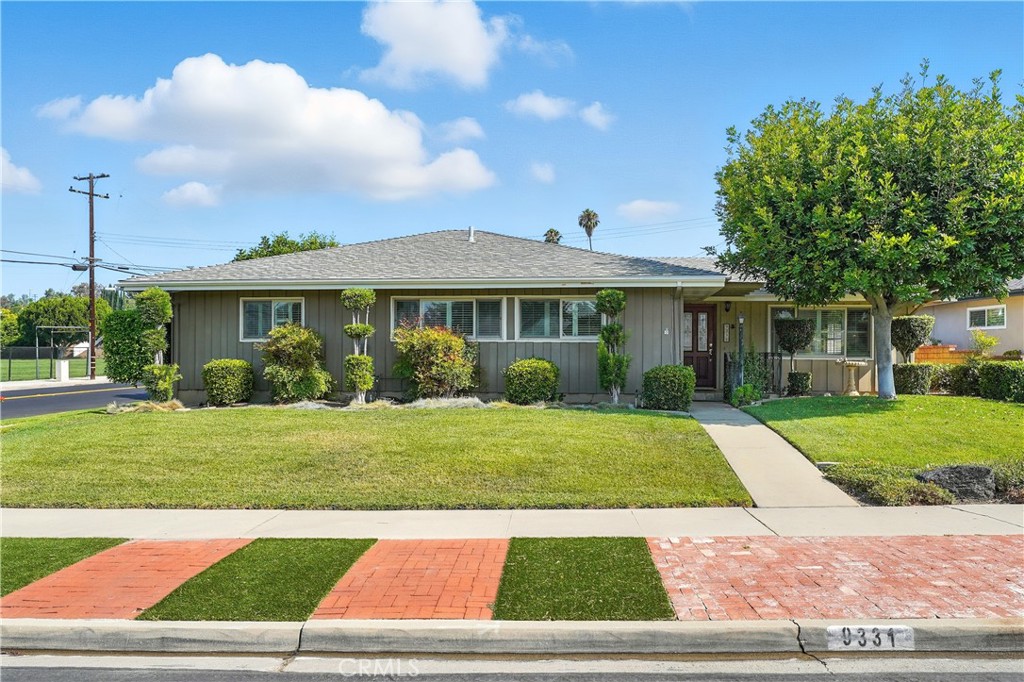 Spacious La Habra Corner Home with Pool!! Welcome to this charming corner-lot home offering over 1,700 sq. ft. of comfortable living space. Featuring 4 bedrooms and 3 bathrooms, this property boasts a versatile floor plan, including a very large bedroom created by combining two rooms—easily convertible back to two separate bedrooms if desired. The inviting family room is the heart of the home, complete with a cozy brick fireplace and an open-concept layout filled with natural light from numerous large windows. The kitchen and living areas flow seamlessly to the covered patio, perfect for outdoor dining or relaxing poolside. For added convenience, there is a three-quarter bathroom (making this one the third bathroom in the house) attached to the garage (unpermitted), ideal for guests or post-swim use. The backyard is a private retreat with a sparkling pool, ready for summer fun. Located within walking distance to an elementary school and just minutes from shopping centers, restaurants, and more—this home offers both comfort and convenience in a desirable La Habra neighborhood.