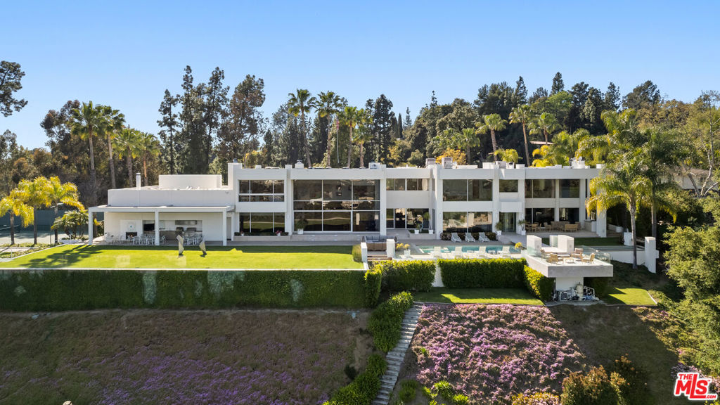 Perched within Pasadena's most coveted enclave, this architectural triumph by Buff, Smith & Hensman is a breathtaking synthesis of modernist design and natural grandeur. Envisioned as a seamless extension of its pristine 3.4-acre surroundings, 300 N San Rafael Avenue commands sweeping panoramas of the Colorado Street Bridge, the historic cityscape of Pasadena, and the San Gabriel Mountains.Originally built in 1997 and thoughtfully expanded in 2002, the residence spans three levels, with walls of glass and 20-foot ceilings that create a seamless connection. Every major living space is oriented toward breathtaking vistas, while warm wood and stone finishes add a timeless quality to the design.The main level features an expansive great room, formal living and dining areas, an open-concept kitchen, a family room, a library, and two guest suites. The upper level is home to a private primary suite with dual bathrooms, two walk-in closets, and a terrace overlooking the grounds. Four additional bedroom suites, an office, and a study complete this floor. The lower level is designed for entertaining, with a wine room, lounge, gym, sauna, and additional guest quarters.Outdoors, a 60-foot pool is uniquely divided by a limestone bridge, creating separate spaces for swimming and relaxation. A championship north-south tennis court, expansive lawn, and a glass-paneled guest house with retractable walls offer additional space for leisure and gatherings. The estate also includes an eight-car garage and offers two separate entries, both gated, for ultimate privacy.With its thoughtful design, unparalleled setting, and breathtaking views, this estate represents a rare opportunity to own a true architectural masterpiece in one of Pasadena's most sought-after neighborhoods. Contact Listing Agents for showing requests.
