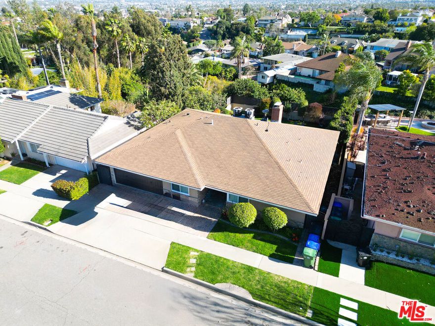 Perched on one of View Park's most coveted streets, this beautifully remodeled home offers breathtaking views from a 45-foot main-level balcony. The open floor plan includes a spacious living and dining area with sliding glass doors, refinished original hardwood floors, high ceilings and abundant natural light. The gourmet eat-in kitchen features custom wood cabinetry, granite counters, stainless steel appliances, an 8-foot island and a separate pantry. Two main-level primary suites boast luxurious ensuite baths, including a massive soaking tub, walk-in closet and double vanities. There's also a dedicated office attached 2-car garage and integrated sound system. The expansive lower level includes a large family room with fireplace, a second full kitchen, two guest bedrooms, a large bath, laundry room, bonus gym/5th bedroom and over 600 sq. ft. of storage space. Enjoy the beautifully rebuilt pool and large backyard deck. Upgraded electrical, plumbing, central HVAC, tankless water heaters audio system and a Tesla-ready charging outlets.