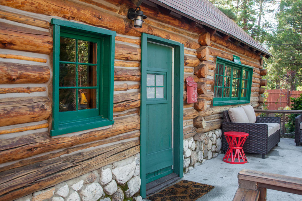 Discover the charm of classic mountain living in this original log home, offering 2 bedrooms and 1 bath, a full kitchen, and a beautifully landscaped, fully fenced yard. Cozy up by the striking rock fireplace in the inviting living area, while the efficient mini-split system provides both heat and air conditioning for year-round comfort. This property also includes a brand new, thoughtfully designed ADU/guest house-complete with 1 bedroom, 1 full bath, laundry hookups, and a full kitchen. The guest house enjoys its own separate, fully fenced and landscaped yard, creating a perfect space for extended family, guests, or additional rental income. This unique setup delivers flexibility, privacy, and the authentic Idyllwild experience, all in one welcoming package.
