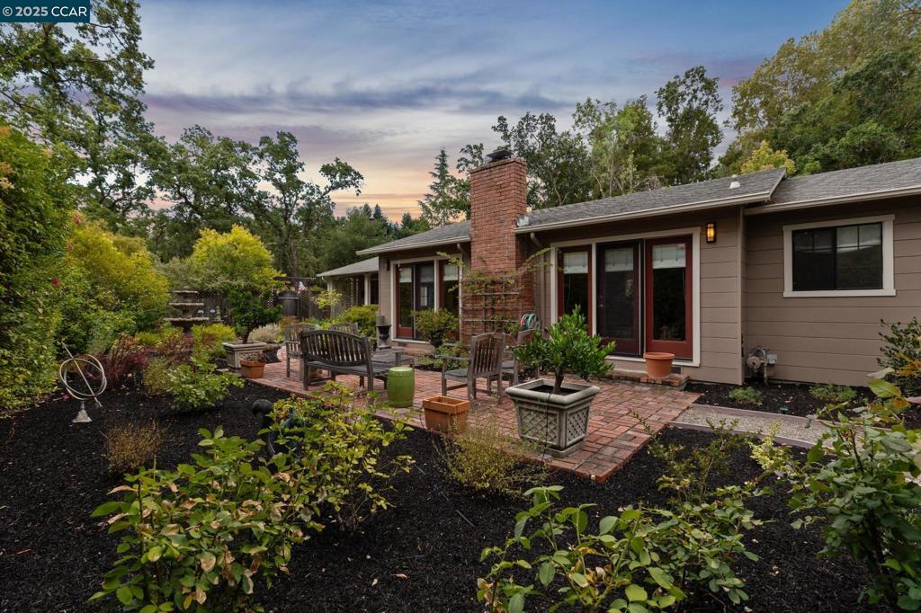 Perched gracefully above the street, this storybook single-story home radiates charm, character, and style at every turn. With 4 spacious bedrooms and 3 beautifully updated baths, the home feels both warm and expansive. The stunning kitchen is a true centerpiece, featuring gorgeous counters, a dreamy backsplash, and perfect flow to both the backyard barbecue and deck, and interior living spaces. The primary suite offers a cozy sitting area, walk-in closet, and spa-like bath.. The inviting living room, with its cozy fireplace, opens through multiple sets of French doors to the brick patio leading to pathways that wind through lush, whimsical gardens. Two dining areas make gathering effortless, whether hosting friends or enjoying a quiet night in. The backyard is serene and peaceful and leads up to a detached artist studio (or office, playhouse, or creative retreat) beside a gorgeous fountain. Just minutes from downtown Walnut Creek’s shopping, dining, BART, and freeways, this enchanting property feels like a private escape in the heart of it all.