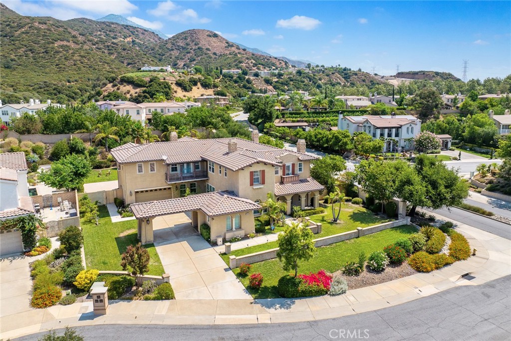 This beautiful 5-bedroom, 5.5-bathroom home is located in the prestigious Stone Canyon in North Claremont. Inside, the residence features a spacious living room, an office, and an elegant formal dining room. It boasts a spacious family room with soaring two-story ceilings and expansive windows, seamlessly connecting to the double island gourmet kitchen equipped with gleaming stainless steel appliances, a spacious breakfast area, overlooking the beautiful garden and pool. There is a ground-floor bedroom with an attached bath, a powder room, and a huge laundry room. The second floor features an oversized master bedroom and bathroom with a fireplace and a retreat area. The other three guest bedrooms all have their own bathrooms. Wood floors and window shutters are featured throughout the entire house, complemented by four fireplaces. Four attached car garages. The backyard includes a basketball court, swimming pool, and built-in BBQ perfect for entertaining family and friends. Wilderness walking trails and parks are nearby. The property is also conveniently close to the Webb Private School, shopping center, Claremont Village and Claremont Colleges.
