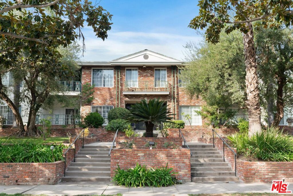 Nestled in the historic Windsor Village enclave of Hancock Park, this elegantly updated two-bedroom, two-bathroom condominium blends classic charm with modern convenience. Located within a distinguished American Colonial-style courtyard building, the residence is set along a tree-lined street, offering a tranquil retreat amid the vibrancy of Los Angeles.Spanning 1,441 square feet on a single level, the home features a spacious living room with crown molding and recessed lighting, seamlessly connecting to a recently renovated open-concept kitchen and dining area. Sliding glass doors lead to a private patio, extending the living space outdoors.Both bedrooms are generously sized, with ample storage, and the two bathrooms are well-appointed. The unit also includes in-unit laundry, additional storage, and two side-by-side parking spaces in a secured garage accessible via elevator or stairs.Residents enjoy the security of a gated, camera-monitored entry and the convenience of a prime location near Larchmont Village, Koreatown, Downtown LA, West LA, Santa Monica, and Century City. The home is just moments from museums, parks, and renowned dining destinations, offering the best of both urban accessibility and residential charm.