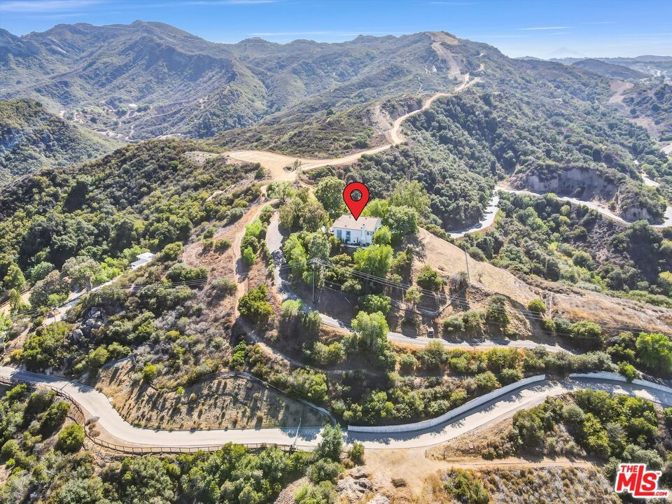 This property is now under auction terms. All Bids must be submitted during the auction period via the property's listing page. Auction starts Monday 8/25 and ends Wednesday 8/27. Call listing agent for more details. A rare opportunity to own a prime hilltop property on more than 7 acres featuring a spacious 3-bedroom, 3-bathroom home set against the backdrop of the Santa Monica Mountains. Located up a private/gated driveway, this hilltop property offers breathtaking views, unmatched tranquility, and direct access to scenic hiking and equestrian trails. Perfectly positioned just minutes from Topanga Town Center and Calabasas, enjoy the convenience of nearby shopping, dining, and entertainment while still feeling a world away. Outdoor enthusiasts will appreciate proximity to Topanga State Park for endless hiking adventures. The vibrant local community adds to the charm, with the Topanga Community Center hosting a weekly farmers market, a playground, and a baseball field, ideal for those seeking a strong neighborhood connection. Whether you're seeking a full-time residence, or a one-of-a-kind investment opportunity, this Topanga gem combines natural beauty, privacy, and the California lifestyle in one extraordinary offering. Occupied/property will not be delivered vacant. Cash only. Sold as-is, occupied, sight-unseen and with no interior access/inspections not available. Contact with occupants is prohibited. Do Not Disturb. A Buyer's Premium of 5% will be added to all winning bid amounts to determine the Total Purchase Price. See auction website for more information. All bids will be subject to seller approval (minimums may apply). Only eligible buyers/bidders (owner-occupants and other approved entities) will be considered within the first 30 days of marketing (until 9/10/25), all buyers/bidders thereafter per CA Civil Code 2924p.