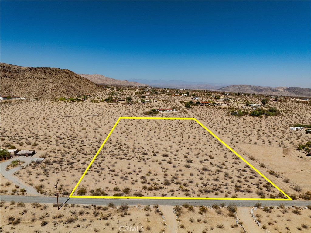 If you've been looking for the ideal property to build your dream desert getaway, you've found it here in this 5.1 acre parcel situated in the serene Sherman Heights area of 29 Palms. This special find sits LESS THAN 1/2 MILE from the border of Joshua Tree National Park, with the park's rugged mountains rising abruptly just to the south of this parcel. Meanwhile, the 49 Palms Oasis hiking trail is practically right outside your door at this peaceful corner lot off Canyon Road. Walk the land and allow your imagination to run wild with the possibilities. You'll be thrilled to note that utilities appear to be available nearby, and the lot seems to be free of any protected native plants, meaning building should be a breeze (buyer to verify all utilities and land use). The land is easily accessible, and its location puts it within a stone's throw of both downtown 29 Palms and Joshua Tree Village so you can easily partake of the shops, restaurants and amenities of either community. Don't miss out on this rare opportunity to own buildable land just outside JTNP – come see this one for yourself and you'll fall in love.