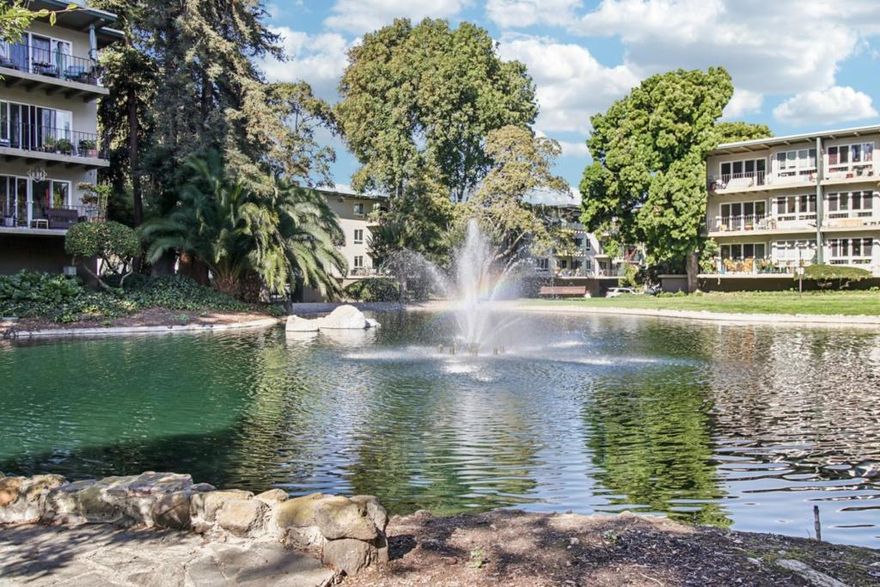 URBAN RETREAT | RESORT-STYLE LIVING | CONVENIENT LOCATION.  Welcome to your resort-style urban retreat in the heart of San Mateo's desirable Woodlake community. Perched on a top floor end-unit with serene views, this beautiful two-bedroom, one-bath home bathes in natural light. Newer floors and numerous custom features set the stage for effortless, move-in-ready living.  Step through the sliding glass doors onto your private tiled deck and use the custom motorized shades to keep cool on hot days.  Inside, custom plantation shutters frame the windows, and custom pull-out drawers line the cabinets.  The renovated bath is complete with a low-step walk-in shower and grab bars, providing style and thoughtful accessibility, and an additional vanity area. Beyond your front door lies a lush oasis of winding walking paths, peaceful fountains and benches perfect for quiet reflection or an early-morning stroll. The community's sparkling pool and spa beckon on sunny afternoons, while the clubhouse, tennis courts, and fitness center provide the perfect gathering spots.  Embrace the balance of tranquility and convenience in a setting that feels a world away, yet conveniently located just minutes from downtown Burlingame, Caltrain, shopping, dining, and major commuter routes.