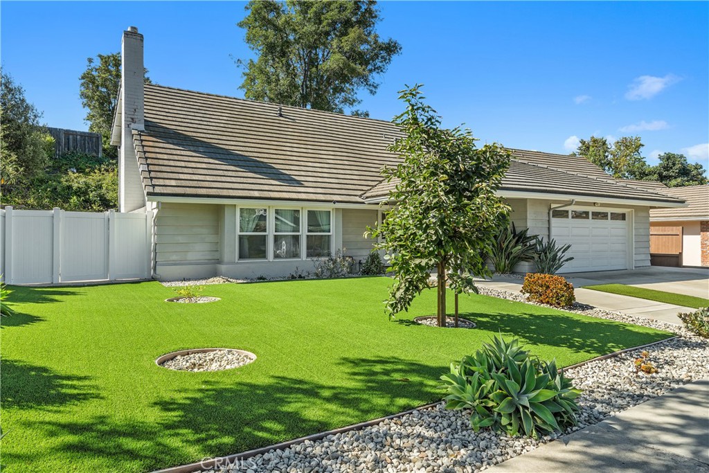 Welcome to 42 Verde Vista Drive, a beautifully updated home nestled in the heart of Thousand Oaks. This charming two-story residence offers over 2,200 square feet of living space, featuring 4 bedrooms and 3 bathrooms—including a convenient bedroom and bathroom on the main level. The home boasts stunning curb appeal with well-maintained landscaping and low-maintenance artificial turf. Inside, you’ll find brand-new laminate flooring throughout, a spacious and inviting living room with a cozy fireplace, and a separate formal dining area perfect for entertaining. The remodeled kitchen showcases elegant marble countertops and flows seamlessly to a sliding glass door that opens to the private, manicured backyard. The first floor also includes an updated ¾ bathroom, an indoor laundry area, and direct access to the two-car garage. Upstairs, the expansive primary suite features ample closet space and a beautifully remodeled en-suite bathroom. Two additional generously sized bedrooms and a third fully renovated bathroom complete the second floor. Step outside to your own serene retreat—lush with mature landscaping, a lemon and persimmon tree, and plenty of space to relax and enjoy the California lifestyle. Additional upgrades include a new HVAC system, dual-pane windows, and a spacious driveway offering ample parking. This turnkey property is a rare find and ready for you to call home!