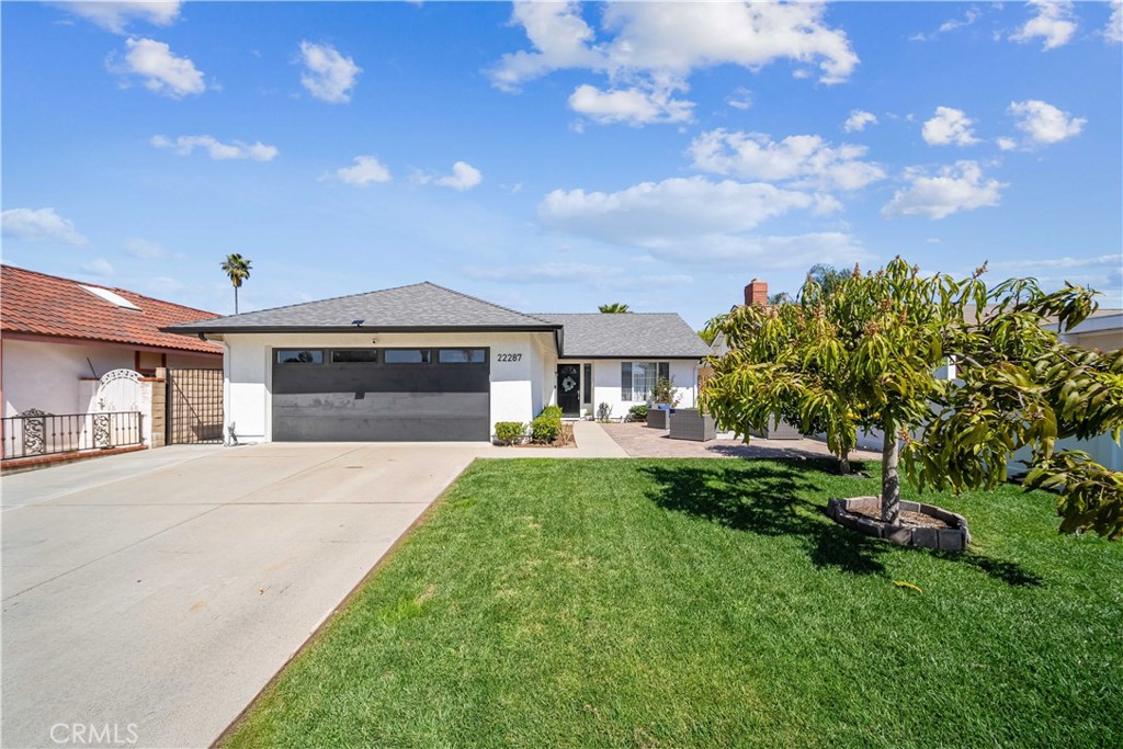 Situated near the scenic Laguna Canyon in the desirable community of Laguna Hills, this beautifully updated single-story home offers the perfect blend of modern comfort and classic charm. From the moment you arrive, a well-manicured front yard and expansive pavered sitting area create an inviting first impression, seamlessly blending indoor and outdoor living. Step inside to discover a bright and airy living space, where natural light highlights the elegant crown molding, fresh paint, and durable luxury vinyl flooring. The recently remodeled kitchen is designed for both functionality and style, featuring sleek quartz countertops, a built-in buffet bar with floating shelves, ample cabinetry, and brand-new stainless steel appliances, including an electric range, microwave, and dishwasher. The open breakfast bar transitions effortlessly into the spacious family room, which boasts a cozy corner fireplace and direct access to the backyard. The primary suite serves as a private retreat, offering a beautifully tiled marble shower, while both bathrooms have been thoughtfully upgraded with a timeless design. The backyard is a private sanctuary, complete with a large pavered patio and space for gardening—ideal for entertaining or unwinding in the fresh air. Additional features include a newer composition roof with updated rain gutters, a low tax rate, no Mello-Roos, and a 220v electric car charger in the garage. Perfectly positioned between Santa Vittoria Park and the San Remo Park tennis courts, this home is conveniently offers quick access to the 133, 405, and 5 freeways. With the Irvine Spectrum just minutes away and Laguna Beach less than 10 miles from your doorstep, this move-in-ready home provides the best of Southern California living!