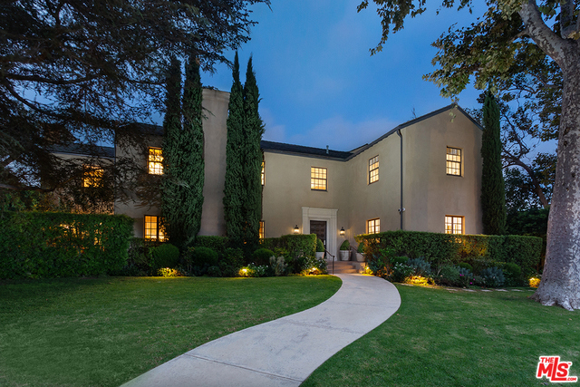 MAJOR REDUCTION! Impressively sited on a lush corner lot & elevated high above coveted Hudson Ave., rests the ultimate Hancock Park Estate. Traditional style home w/modern flair. Classic Center Hall floorplan. 6 large Bedrooms, 9 Bathrooms. Spacious public rooms w/hardwood, recessed lights & crown molding. Entry Hall w/stenciled floor. Living Room w/coffered ceiling & fireplace. Formal Dining Room. Library & Music Room with multiple French doors. Pièce de résistance is the massive Great Room, combining the open Kitchen & Family Room into an extraordinary communal space where all can dine & relax. Chef's Kitchen w/huge island peninsula. Sprawling Master w/dual baths, 2 walk-in closets & separate Study. 5 additional Bedroom Suites. Tiered rear yard w/ground level entertaining space & an extended swim-lane pool perched majestically above. Adjacent Cabana perfect for poolside recreation. Walled & gated for privacy. A truly wonderful estate property worthy of its distinguished address!