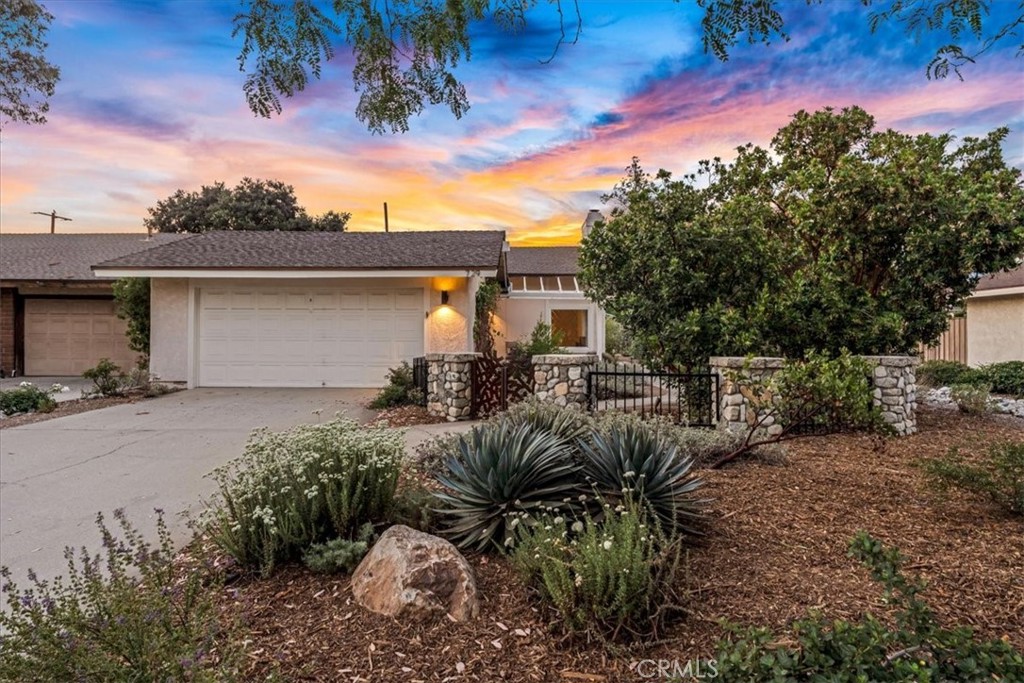 Serene Single Story Patio Home in University Terrace! Located in North Claremont near The Claremont Club, this elegant single-story home pairs a spacious layout with serene outdoor living and native landscaping. A private gated courtyard welcomes you with a serene pathway that guides you to a raised wooden deck. Through the front door, newer flooring extends throughout the home, enhanced by an abundance of natural sunlight. Anchored by a classic brick fireplace, the spacious living room is elevated by a central atrium that fills the space with natural light and visual intrigue. Just off the living room, the dining area provides a comfortable space for meals, with direct access to the side yard. The kitchen is tastefully updated to blend modern convenience with a refined aesthetic, outfitted with stainless steel appliances, including a premium Sub-Zero refrigerator. The large butcher block enhances overall functionality of the kitchen. The home features three generously sized bedrooms and two bathrooms, each with dual sinks. The primary suite stands out with its access to the indoor atrium and a spacious deck providing additional outdoor space for lounging. The primary bathroom has been remodeled with modern finishes, including stone counters, attractive mirrors & a spacious walk-in shower. The outdoor areas offer both privacy and flexibility, featuring a spacious deck perfect for lounging, outdoor dining, or entertaining. Mature citrus trees provide vibrant color and charm, while garden beds offer opportunities for planting or personal touches. Whether you envision an outdoor kitchen, a cozy play space, or an expanded garden retreat, the layout allows for easy customization. Surrounded by lush greenery and thoughtful landscaping, the backyard offers a serene environment designed to evolve with your lifestyle while maintaining comfort and functionality.