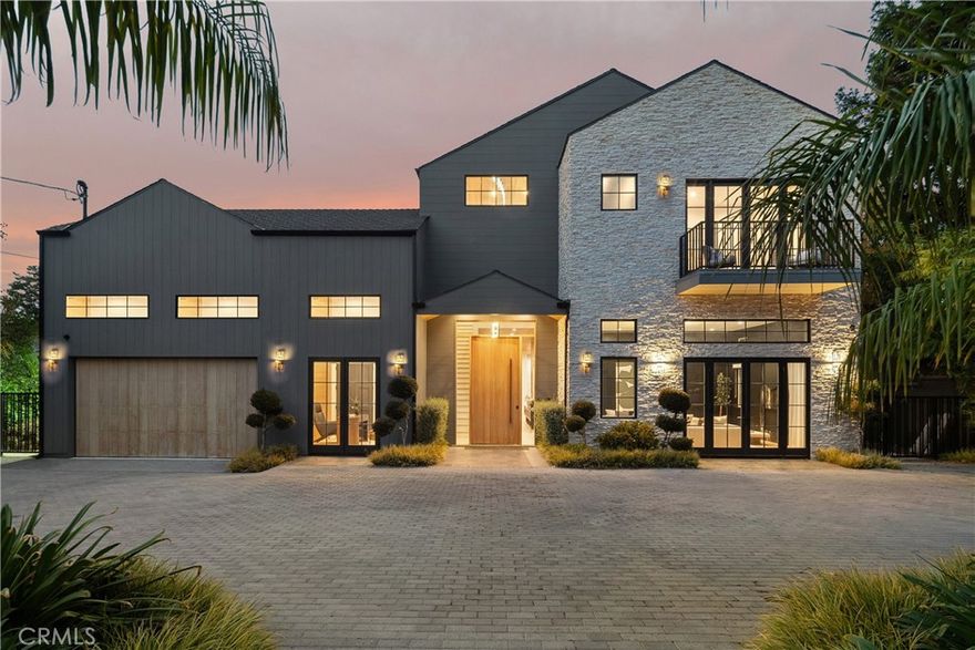 Tucked behind private gates on nearly half an acre in the heart of prime Woodland hills, this newer-construction estate features a 5-bed, 6-bath main residence and 1-bed, 1-bath ADU. Designed for modern living, the bright and airy open-concept floor plan is accentuated by lofty ceilings and wide-plank European floors that carry throughout the home. A culinary enthusiast's dream, the designer kitchen comes equipped with premium Thermador appliances, double islands and a large walk-in pantry. The formal dining room effortlessly connects the kitchen with the spacious family room, creating a seamless flow for entertaining and everyday living, while a floor-to-ceiling sliding glass door opens to extend your living space outside. Completing the main level is an inviting formal living room, state-of-the-art home theater and ensuite bedroom. Head upstairs to find four generously sized ensuite bedrooms and a dedicated laundry room. The luxurious primary suite boasts two private balconies, a custom walk-in closet and spa-inspired bathroom, complete with an oversized steam shower, soaking tub, dual water closets, dual vanities and a separate makeup vanity. Reminiscent of a five-star resort, the expansive backyard retreat is surrounded by mature privacy hedges and features a sparkling infinity-edge pool with a massive spa, a sports court, outdoor kitchen with bar seating and an in-ground fire pit. Perfect for extended family, guests or as additional living space, the versatile ADU has its own address, a living room with a full kitchen, bedroom, bathroom and walk-in closet. Additional highlights include a Control4 smart home system that operates the built-in speakers, lights and thermostat, a security system, wine storage, two-car garage and circular driveway. Located south of the Boulevard, this exceptional property offers convenient access to shops, restaurants, the 101 freeway and so much more.