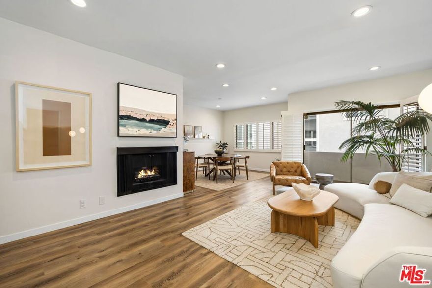 Top-floor, rear-corner home in the heart of Brentwood, quiet, bright, and beautifully updated. An open living/dining area spills onto a private balcony, perfect for morning coffee or alfresco dinners, while a separate office nook makes working from home easy. The remodeled kitchen is a standout with a skylight, custom cabinetry, quartz countertops, subway-tile backsplash, apron/farmhouse sink, and stainless-steel appliances. The serene primary bedroom features a spa-like bath with a soaking tub and a separate shower. The second bedroom is well-sized; the second, remodeled bath sits just outside in a private hallway for added privacy. Wide-plank wood-style floors, recessed lighting, in-unit stackable washer/dryer, and central air conditioning complete the interior. Two-car tandem parking plus extra storage. Well-maintained building with a newly refreshed heated pool & spa, sauna, BBQ/pool area, rec room, elevator, and EQ insurance. Stellar location moments to San Vicente & Wilshire shops, dining, and the Brentwood Farmers Market.