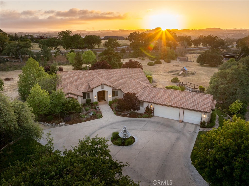 Discover the perfect blend of luxury and country living with this custom 4-bedroom home set on five usable acres in the highly sought-after Spanish Camp neighborhood of Paso Robles. Designed for comfort and versatility, this spacious residence features separate living and family rooms, a private office, an exercise room, a large laundry/utility room, and a custom wine closet—ideal for entertaining and everyday living. High-end finishes throughout include rich mahogany cabinetry, granite countertops, stainless steel appliances, and a butcher-block island, all accented by beautiful architectural arches. Outside, enjoy a smooth hand-troweled stucco finish, majestic mature oaks, and an inviting in-ground swimming pool. The property is well-suited for farm animals or horses, with a corral and stall already in place, plus a rare, year-round running creek. A spacious three-car garage adds convenience to this truly exceptional Paso Robles retreat.