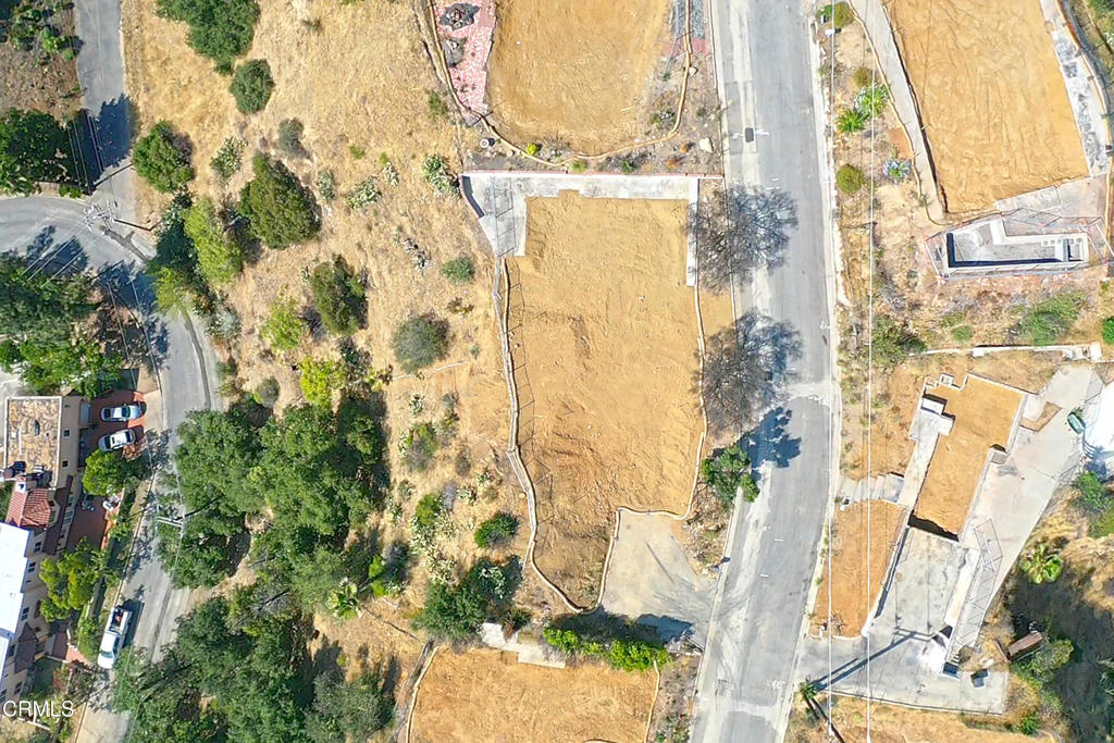 Perched at the top of the prestigious Zane Grey Terrace neighborhood, this premier lot offers sweeping views of the city and the San Gabriel Mountains. Spanning 18,589 square feet, the lot features a generous flat pad and slopes down the hillside, offering potential to expand its residential footprint. Whether you choose to rebuild the previous home or design a completely new residence, this property is a blank canvas ready for your vision. Imagine a sleek modern retreat, a Mediterranean Revival, or a spacious ranch style home. The location provides a rare blend of privacy and accessibility, just minutes from scenic hiking trails, local shops, and Pasadena's world class cultural destinations. The property is being sold as is. Phase 2 Phase 2 Debris Removal has been completed by the US Army Corps of Engineers of Engineers. A previous three bedroom, two bathroom Traditional style home once stood on the lot, totaling approximately 2,029 square feet.