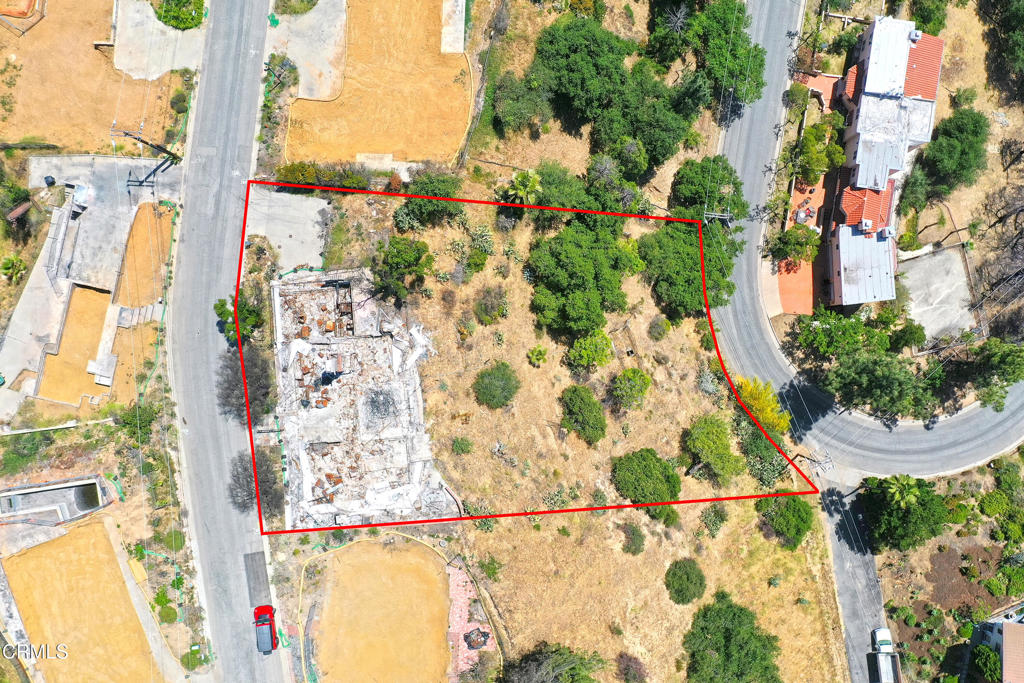 Perched at the top of the prestigious Zane Grey Terrace neighborhood, this premier lot offers sweeping views of the city and the San Gabriel Mountains. Spanning 18,589 square feet, the lot features a generous flat pad and slopes down the hillside, offering potential to expand its residential footprint. Whether you choose to rebuild the previous home or design a completely new residence, this property is a blank canvas ready for your vision. Imagine a sleek modern retreat, a Mediterranean Revival, or a spacious ranch style home. The location provides a rare blend of privacy and accessibility, just minutes from scenic hiking trails, local shops, and Pasadena's world class cultural destinations. The property is being sold as is. It has been enrolled in Phase 2 debris removal by the U.S. Army Corps of Engineers and is pending completion. A previous three bedroom, two bathroom Traditional style home once stood on the lot, totaling approximately 2,029 square feet.