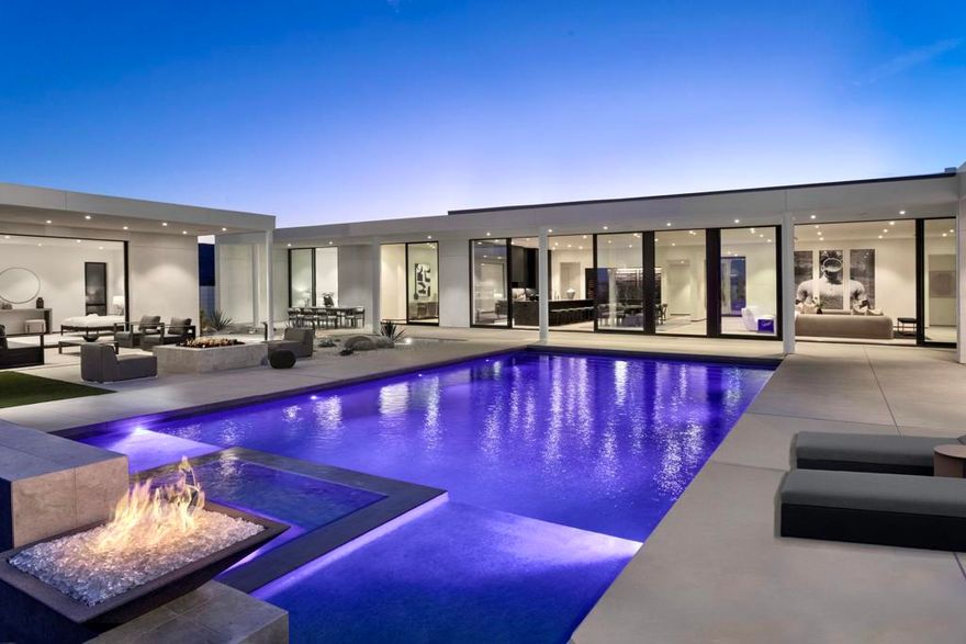 Residence Fourteen in Linea Rancho Mirage presents the essential qualities of desert resort architecture--providing a long central pavilion with a series of flexible living spaces throughout. Our interior design team created a warm environmental pallet of natural woods and bespoke black stone surfaces, producing a 'Zen like' ambiance with modernist intentions of space and light. The glass hallway to the master suite is emblematic of the classic indoor/outdoor connections throughout the residence to the surrounding desertscapes. A complete guest house reflects the same design elements as the main residence and can be utilized for independent  living, a luxurious suite for visitors or accommodations for full-time staff.This 4,737 square foot 5 bedroom home is replete with luxury features and finishes: Wolf & SubZero appliances including a wine tower, Aranelli Italian cabinetry, seemingly endless facades of floor-to-ceiling Fleetwood glass, spa inspired main bath with steam shower, solar arrays and batteries, pebble finish salt water pool and more.A modern peaceful desert oasis like no other.