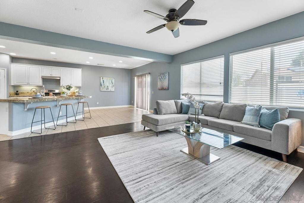 Welcome home to your 6-Bedroom Home with 3 Full Baths. This beautifully designed home, perfect for growing families or anyone in need of extra space. The open-concept layout features soaring vaulted ceilings and stylish dark wood-look flooring, creating a warm and inviting atmosphere throughout the main living areas. The first floor offers a convenient bedroom and full bathroom—ideal for guests or multi-generational living—as well as a large laundry room equipped with a washer and dryer. The gourmet kitchen is sure to impress, boasting abundant cabinetry, sleek granite countertops, a walk-in pantry, and a modern 5-burner range. The kitchen flows effortlessly into the living room, where you’ll enjoy high ceilings and a cozy gas fireplace—perfect for relaxing or entertaining. Upstairs, discover a spacious loft with built-in storage and a dedicated desk area, making it easy to work or study from home. Five additional bedrooms upstairs provide generous closet space and attractive wood-style flooring. The master suite is set apart for privacy and relaxation, featuring a roomy closet and a luxurious soaking tub. Step outside to a backyard designed for enjoyment and convenience, complete with a nearly new Tuff Shed and three fruit trees—fig, pomegranate, and apricot. The four-car, pull-through garage is a rare find, offering plenty of space for vehicles, hobbies, or storage. This home truly has it all—space, style, and functionality. Don’t miss your chance to make it yours!
