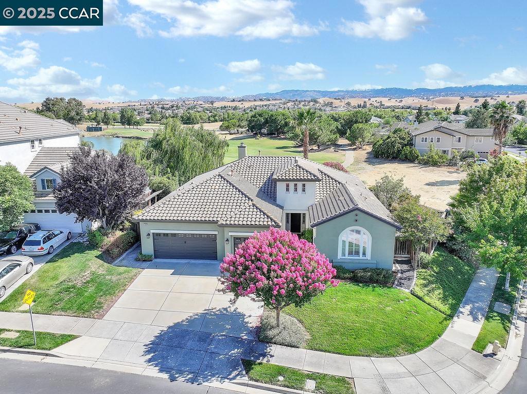 Beautifully updated 3 bedroom plus den single-story home on a premium corner lot overlooking the Shadow Lakes Golf Course with stunning views of the fairways and East Bay hills. This open and bright floor plan features formal living and dining rooms, a spacious family room, and an updated kitchen highlighted by a large center island with a stunning natural wood countertop. The primary suite offers backyard access and additional sweeping views, plus a 5-piece bath and two closets, including a generous walk-in. Two guest rooms share a Jack-and-Jill bath at the front of the home, while a large den/office could easily convert to a 4th bedroom with access to the third full bath. The finished 3-car garage includes epoxy floors and built-in cabinets. Enjoy outdoor living with a stamped concrete patio, built-in BBQ island, and shaded gazebo. All in a desirable neighborhood zoned for Brentwood’s top-rated schools. A rare opportunity to own a golf course view home in a fantastic location!