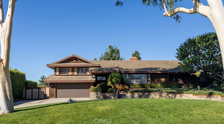 Nestled in the peaceful Friendly Hills community, this beautiful home offers privacy, character, and warmth at every turn. A circular driveway provides extra parking and a welcoming first impression, while French wood-framed windows fill the home with natural light and timeless charm. The spacious living room features a dual fireplace that opens to a cozy family room and library area—perfect for relaxing or gathering with loved ones. The updated kitchen includes a comfortable eating area and breakfast bar, making it a great spot for morning coffee or casual entertaining. A large formal dining room offers wonderful views of the private backyard. The thoughtful layout includes a separate bedroom and bath, ideal for guests or a mother-in-law suite. Step outside to a backyard designed for both fun and relaxation, with a sparkling pool, inviting seating areas, a sun deck, and a pool house complete with sink, shower, and bathroom. Full of charm, warmth, and privacy, this home is truly a special place worth seeing.