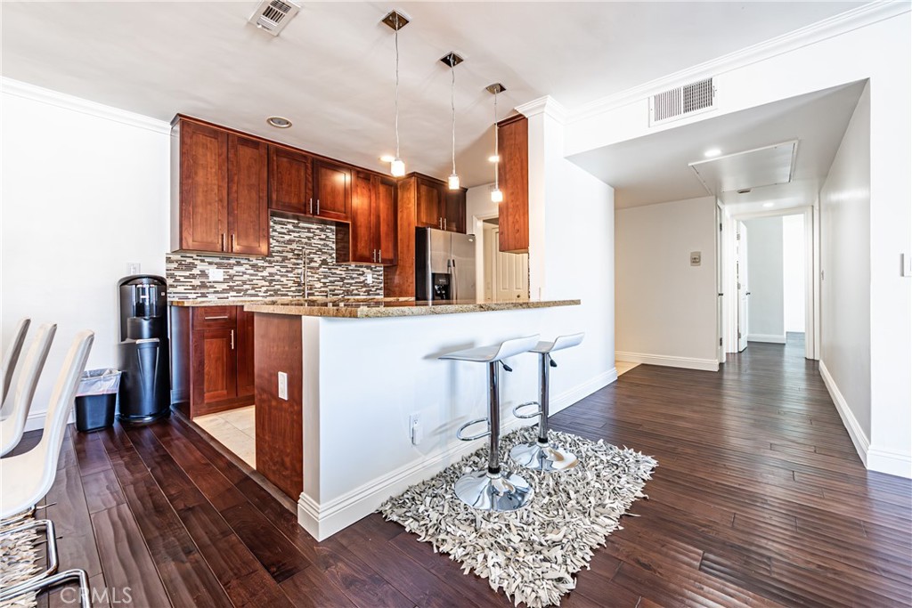 Welcome to this beautifully maintained 2-bedroom, 2-bathroom condo offering comfort, convenience, and style. Step inside to find stunning wood floors that flow throughout the open living space, creating a warm and inviting atmosphere. There is a large balcony off the living. The spacious layout includes a well-appointed kitchen, generous bedrooms, and two full bathrooms, perfect for both everyday living and entertaining. Enjoy the perks of secured access for added peace of mind, along with access to a sparkling community pool for relaxing and unwinding. With a low HOA, this property is an ideal opportunity for homeowners or investors alike.