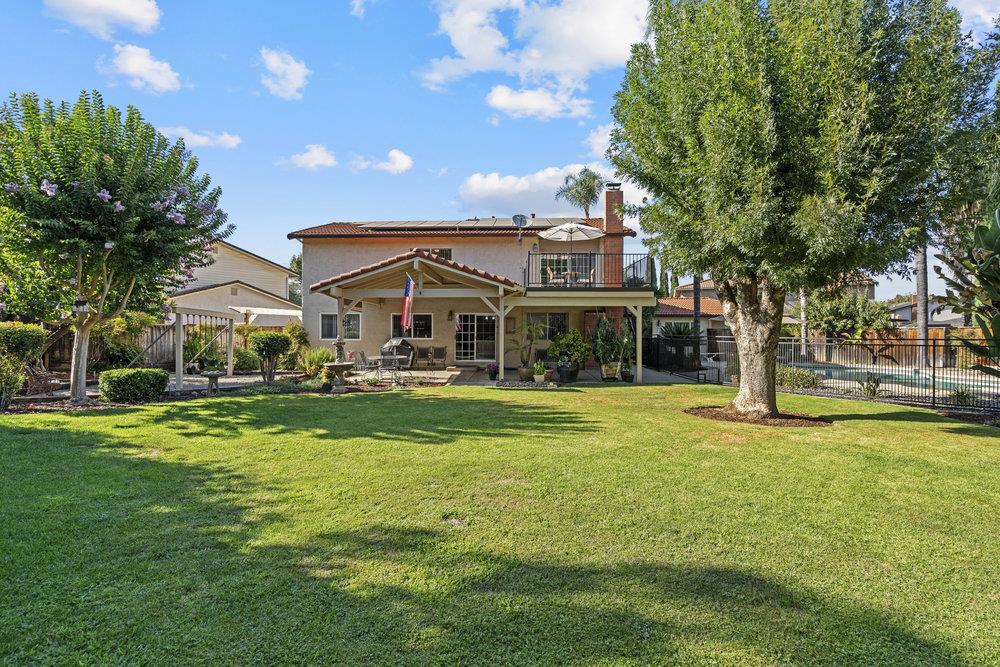 Welcome To Your Oasis! This spacious 5-bedroom, 2,814 sq. ft. home sits on a generous 12,570 sq ft lot and offers the perfect blend of comfort,entertainment, and opportunity. Relax year round with a heated pool and spa, or host gatherings under the covered patio surrounded by mature landscaping-an entertainer's dream. Inside you will find a beautiful, updated, well maintained home featuring a large laundry room, open kitchen, a family room with fireplace, a formal dining room and living room. Upstairs are five bedrooms, two updated full baths, including a spacious primary suite with walk-in closet and a brand new private Trex deck retreat. Includes oversized bedroom that will accomodate all your needs. Enjoy the comfort of central AC and a whole house/attic fan, ensuring a cool atmosphere throughout with included solar to help keep the electric bill low. This home also boasts incredible potential for an ADU, in-law suite, workshop, or pool house, with an updated half bath, it's ready to fit your vision! Perfect for large families, multi-generational living or those seeking rental income opportunities, this home is tucked away on a cul-de-sac near schools, commuter routes, walking trails, and shopping. A must see property offering space, style, and endless possiblities!